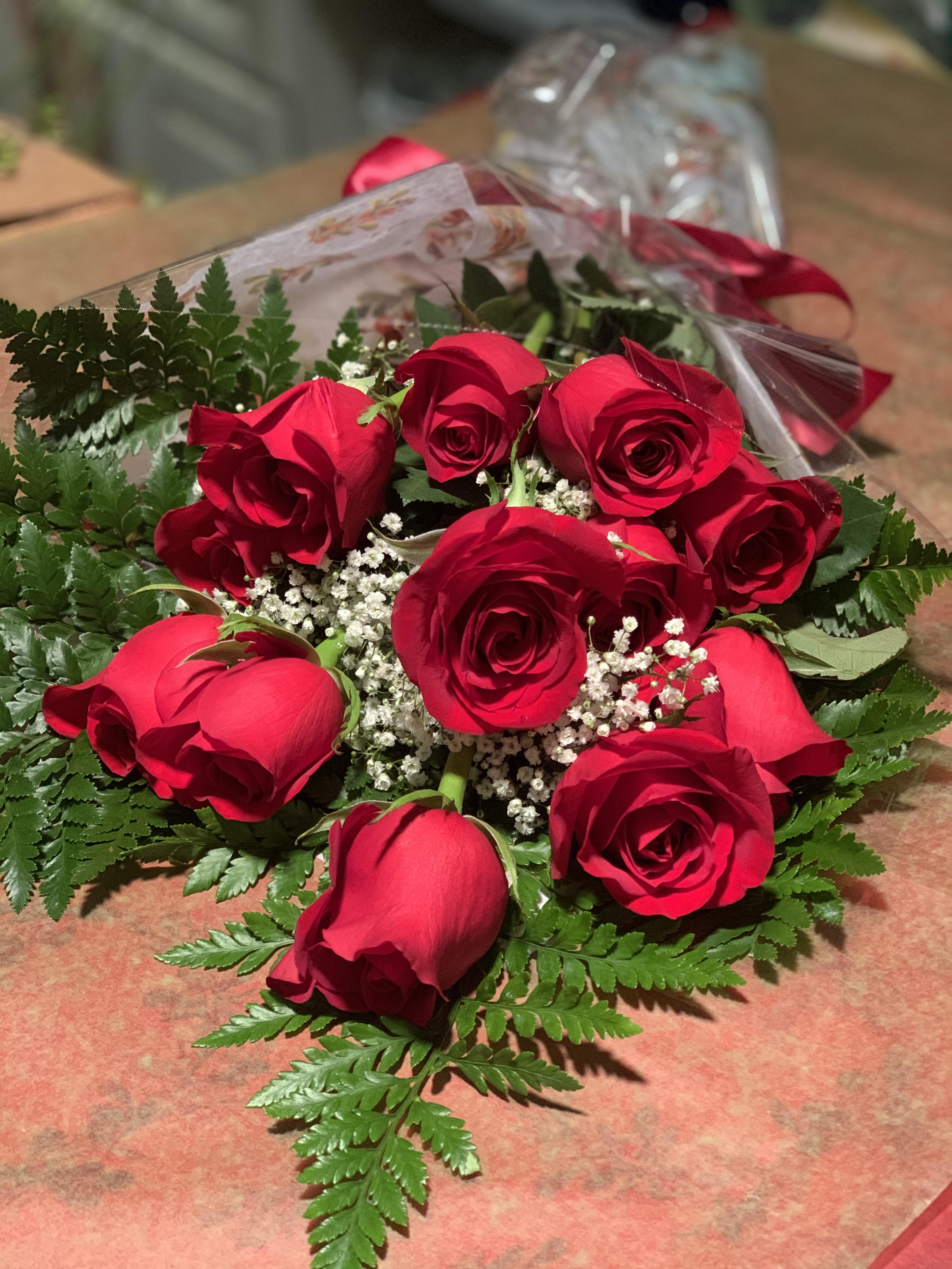 Bouquet of red roses with baby's breath and fern foliage
