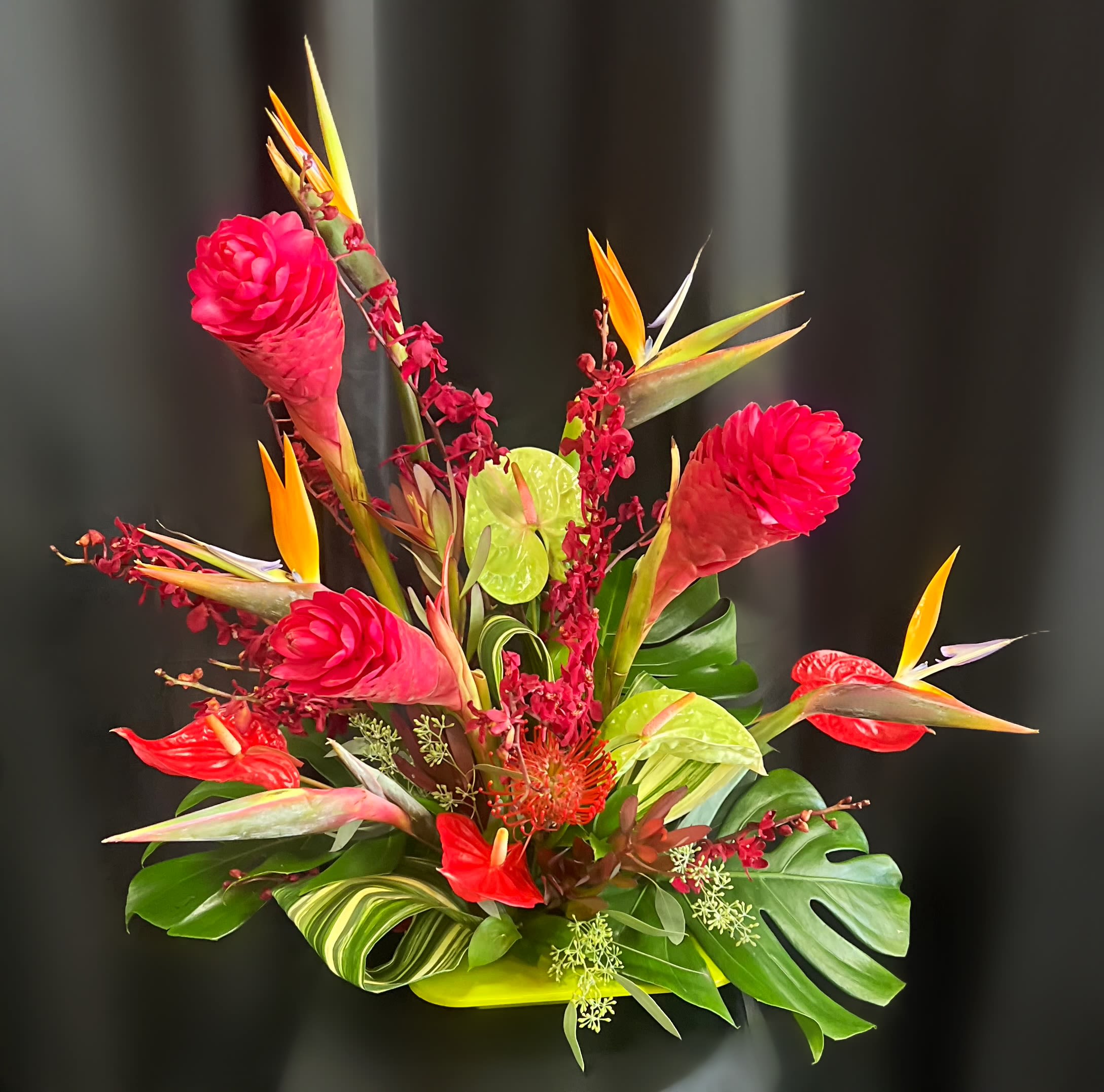 Tropical bouquet with red ginger flowers and bird-of-paradise blooms