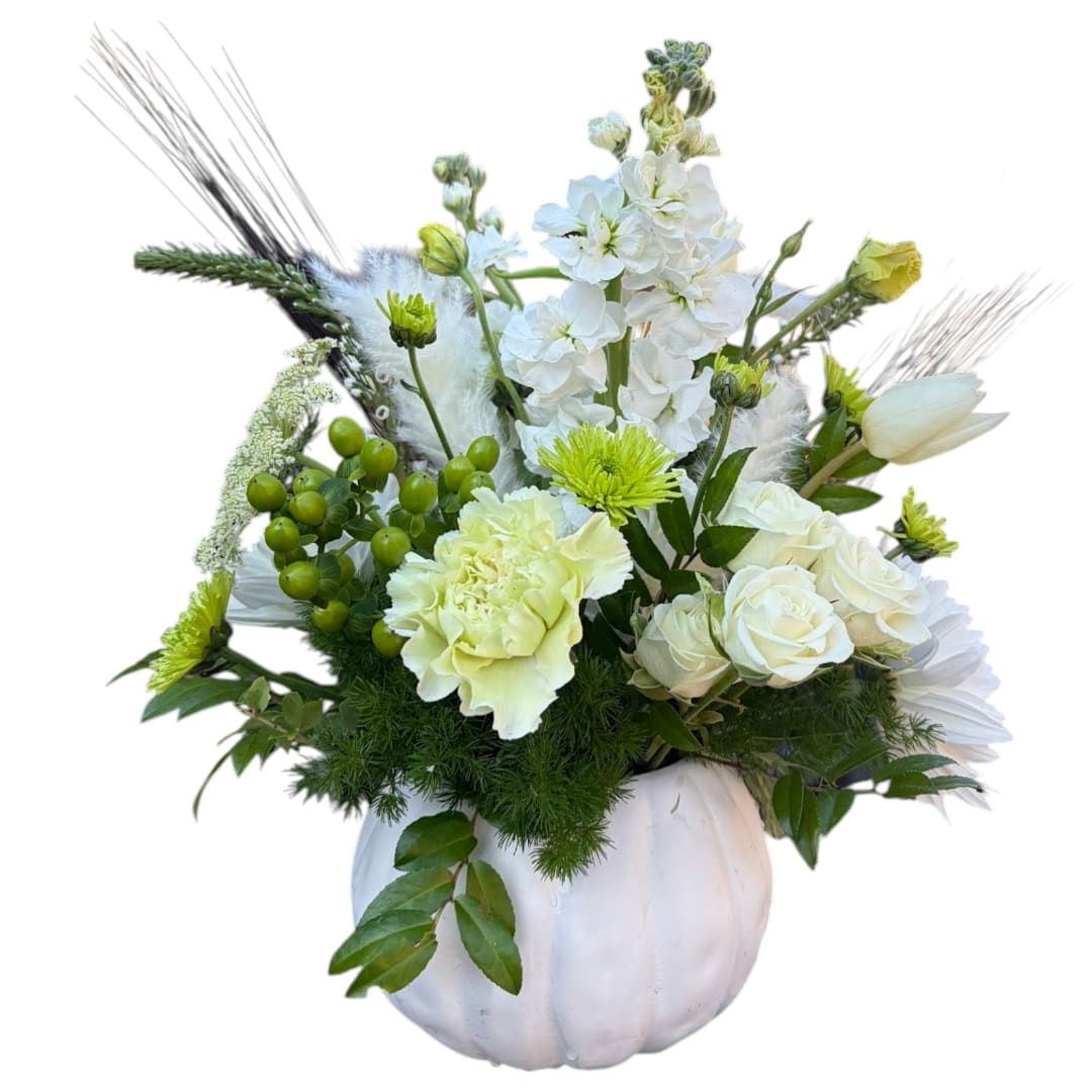 White floral arrangement in a white pumpkin vase with green accents