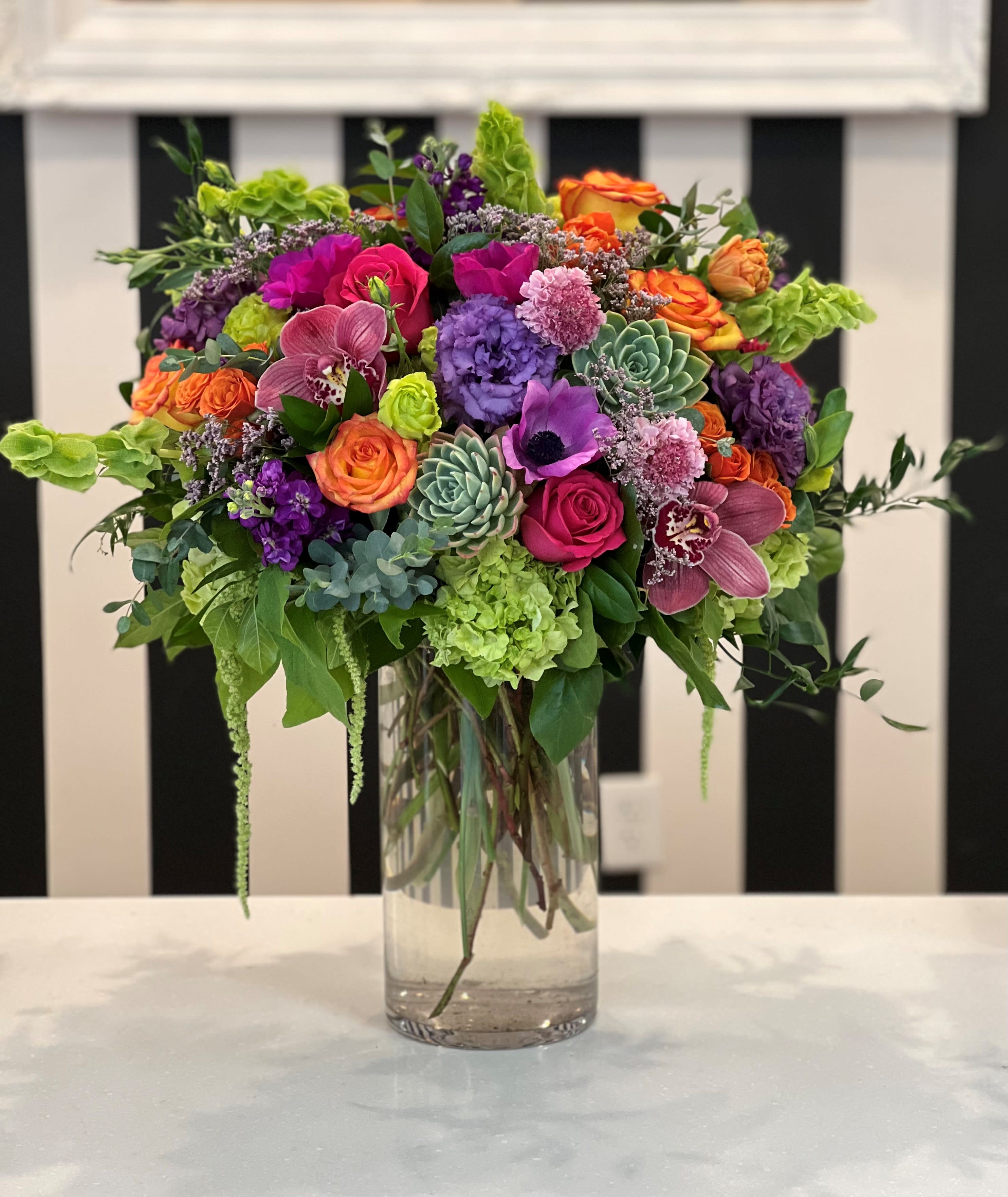 Colorful mixed flower arrangement in a clear glass vase
