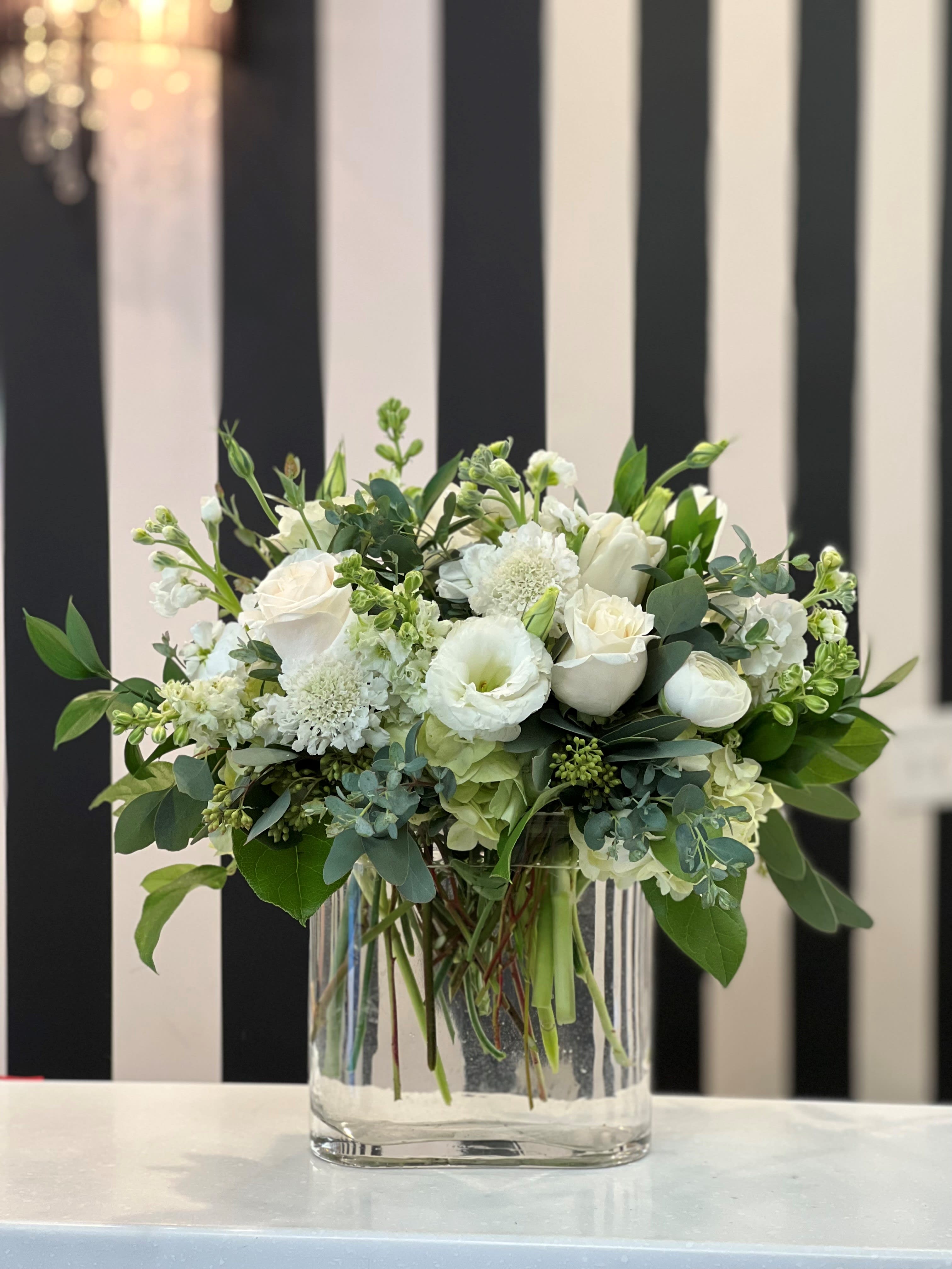 White floral arrangement in a clear glass vase