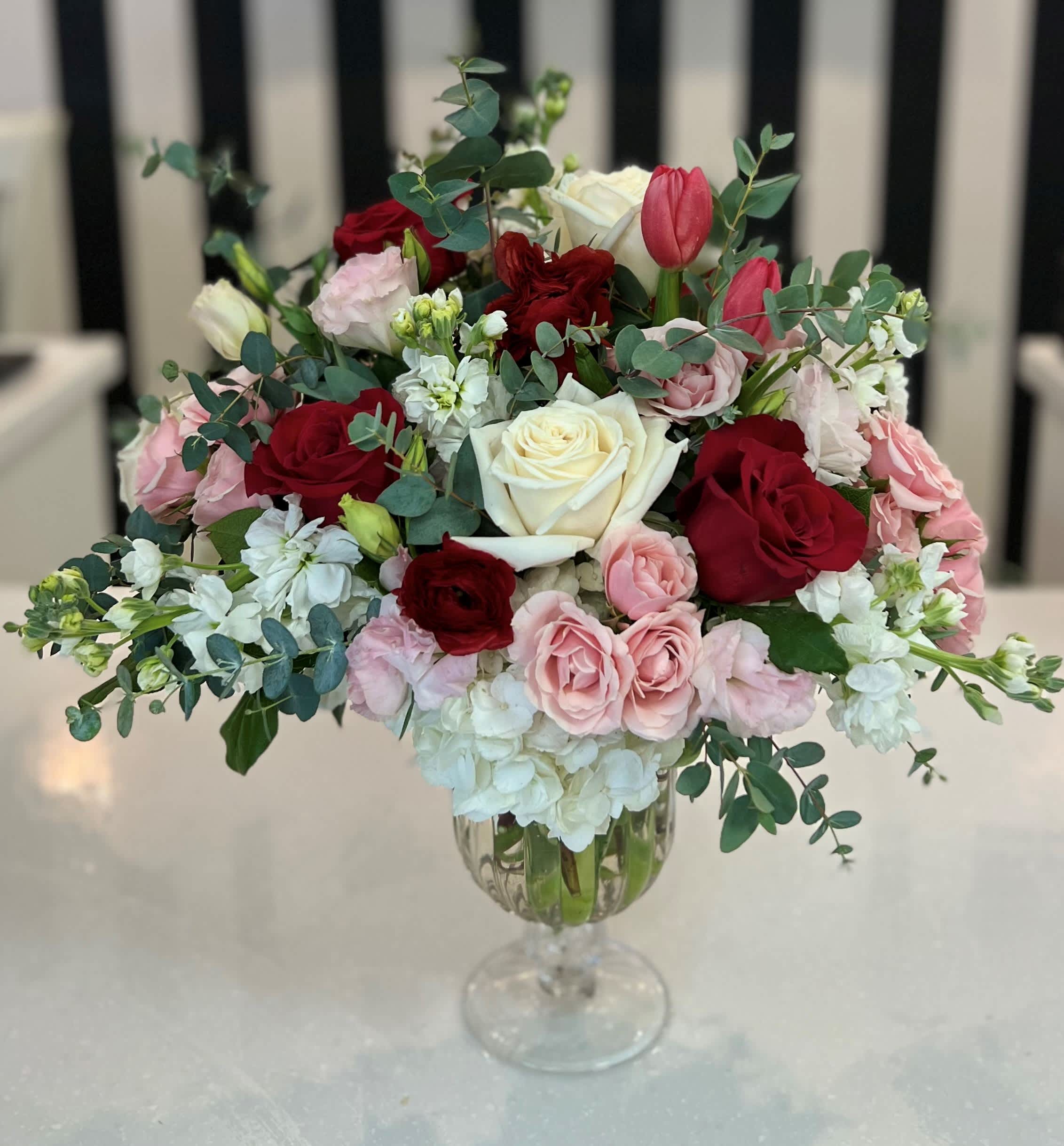 Mixed roses and tulips in a clear glass vase
