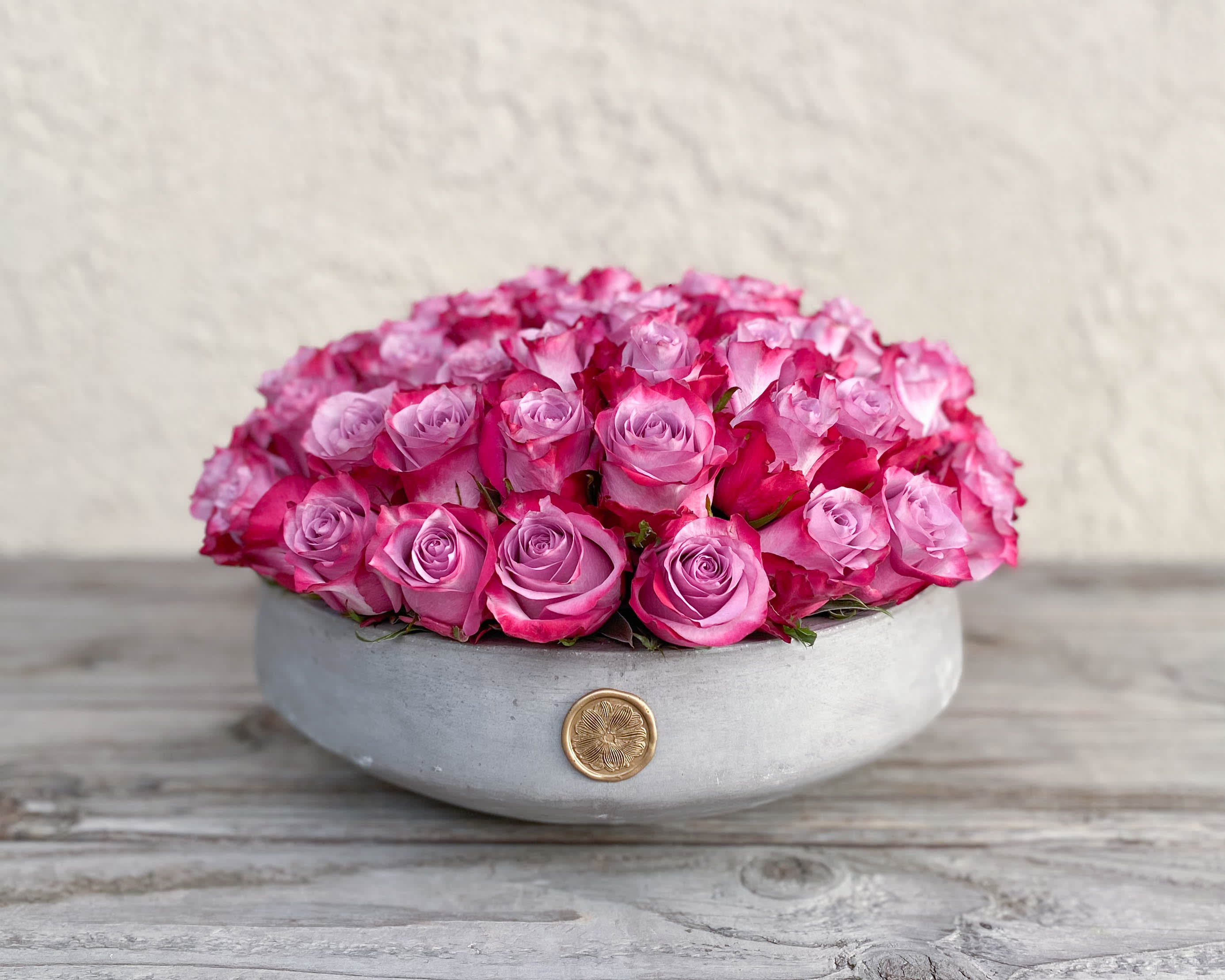 Round box filled with pink roses