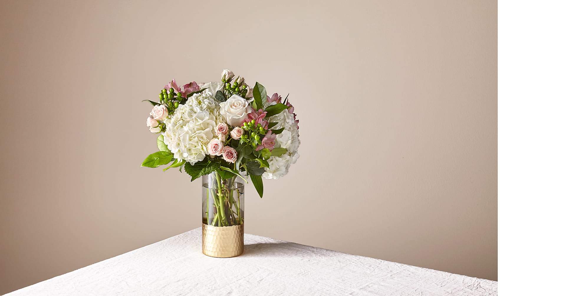 Bouquet of white and blush flowers in a glass vase