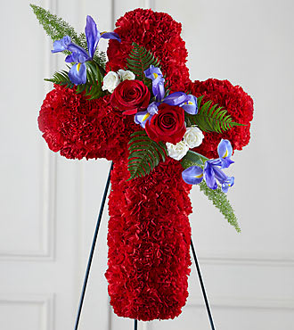 Red floral cross on a stand with roses and blue flowers