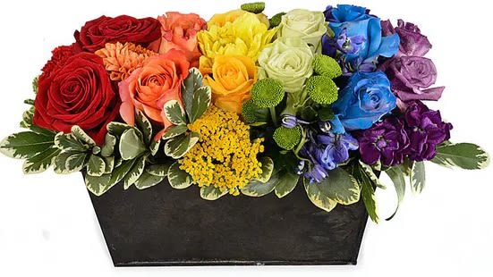Rainbow rose arrangement in a black rectangular container