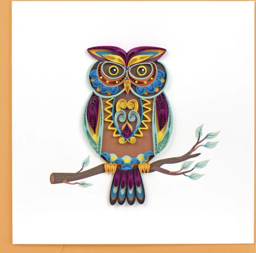 Colorful quilled owl perched on a branch against a white background