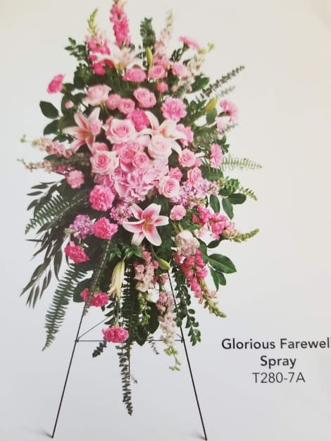Pink funeral spray on a standing easel with lilies and roses