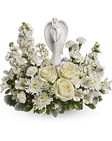 White floral arrangement with an angel figurine centerpiece
