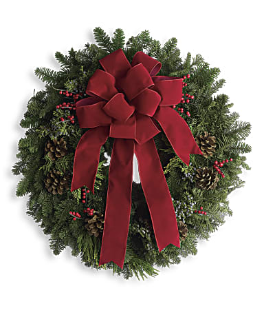 Christmas wreath with a red bow, pinecones, and red berries