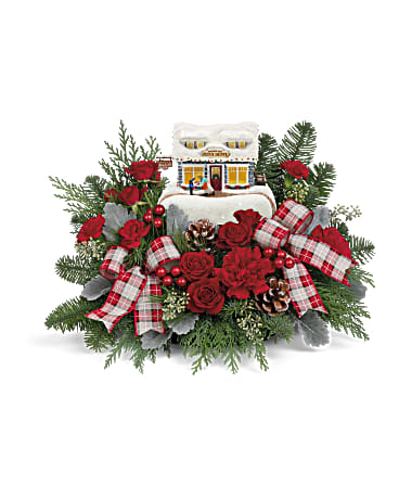 Christmas floral arrangement with red roses, plaid ribbons, and a small house ornament