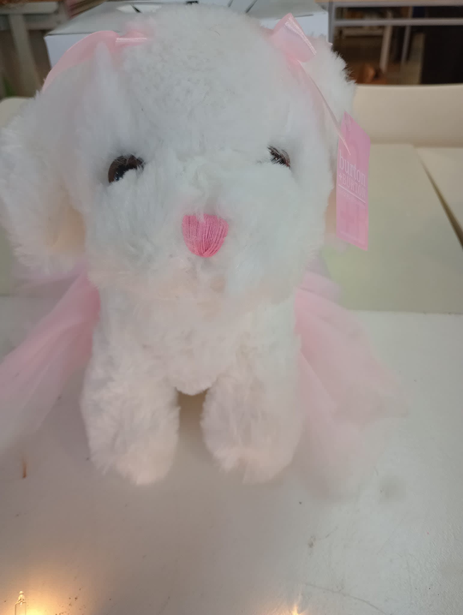 White plush bunny with pink ribbon accents and a pink nose