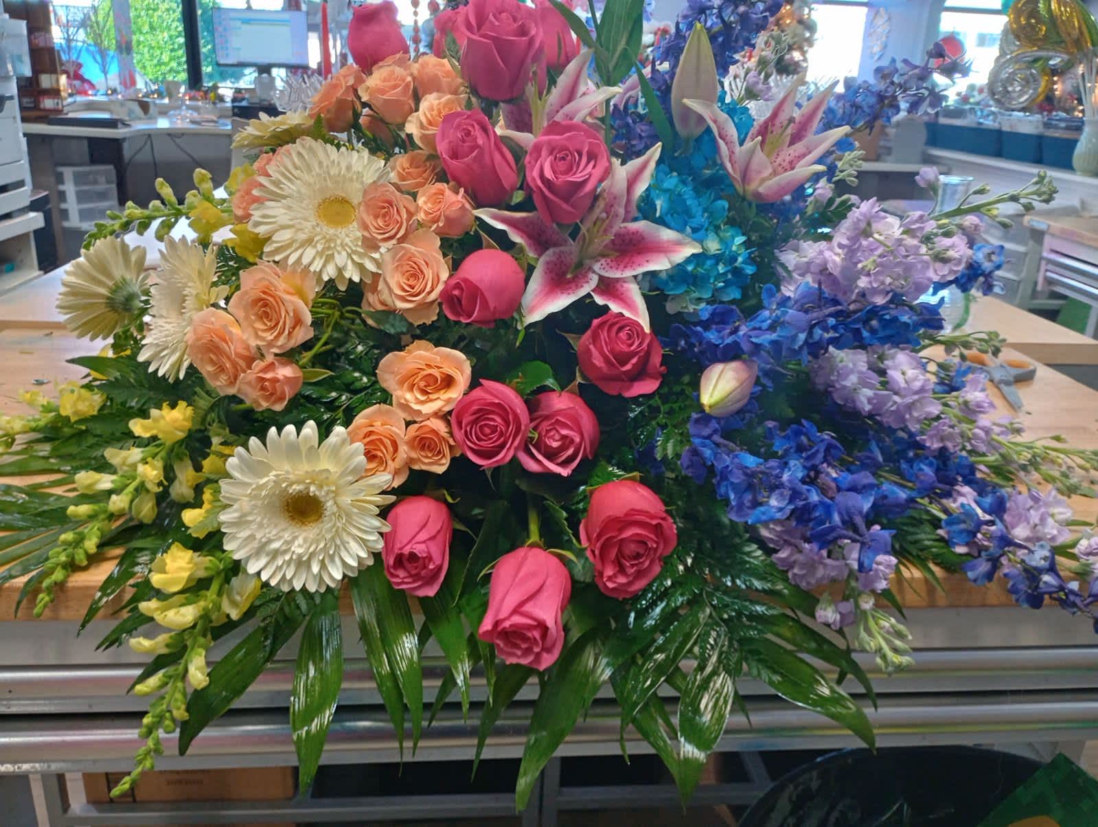 Large mixed bouquet with pink roses, white daisies, and blue flowers