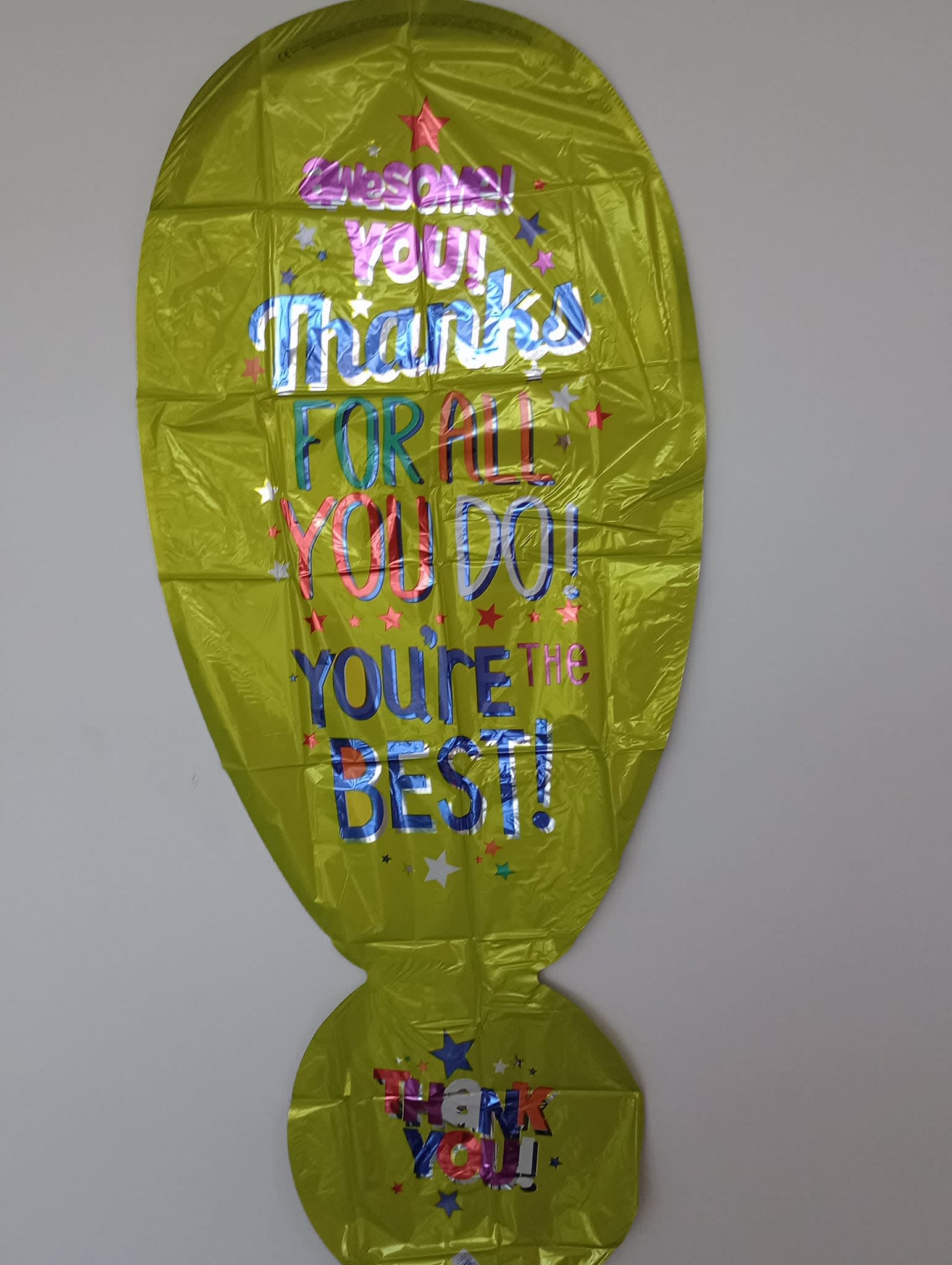 Yellow foil balloon with colorful thank-you text and stars