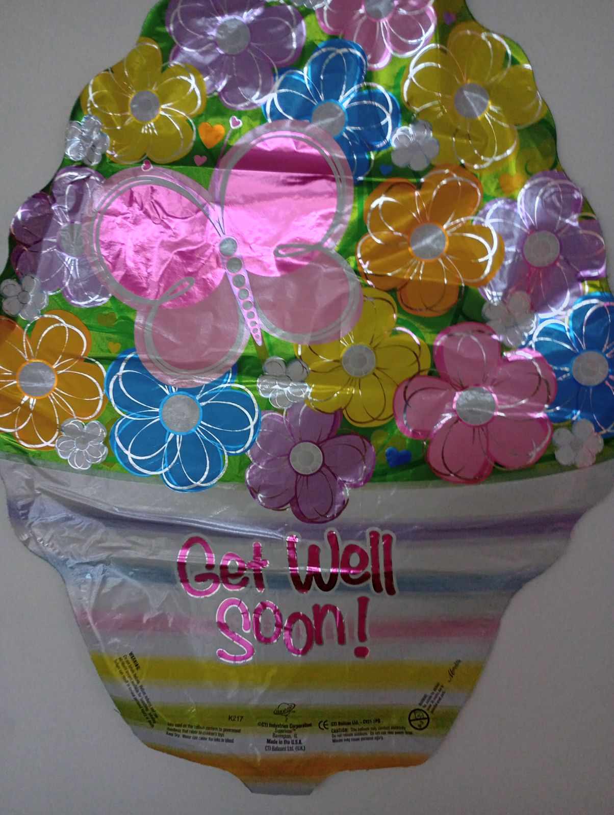 Colorful flower-shaped foil balloon with "Get Well Soon!" text