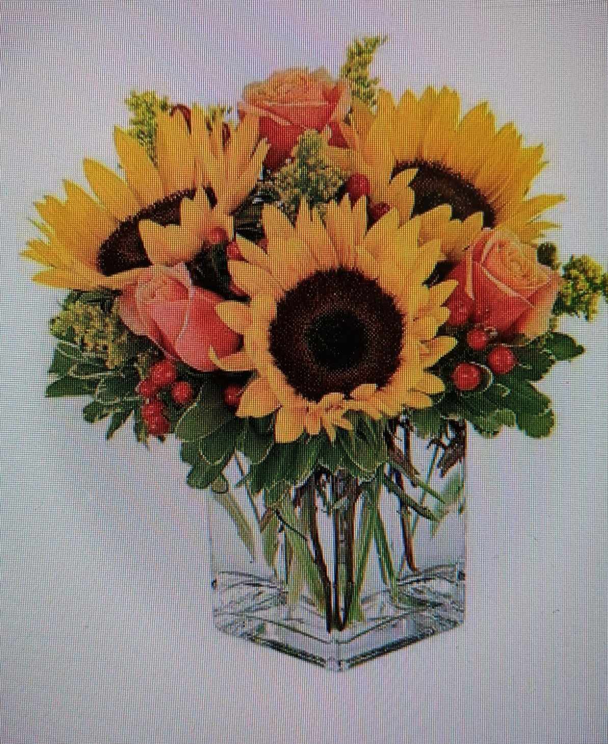 Sunflower bouquet with pink roses in a clear square vase