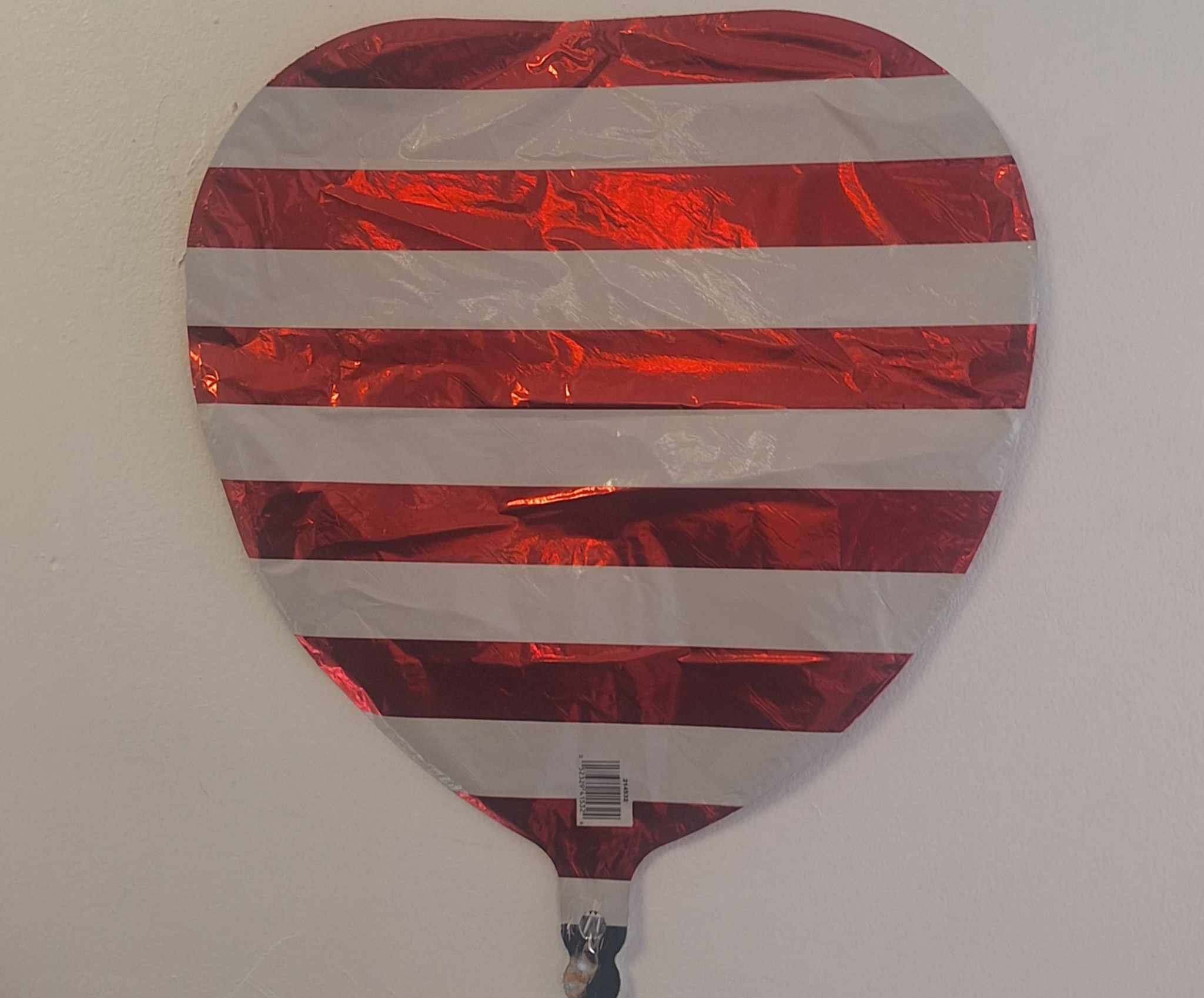 Red and white striped heart-shaped foil balloon