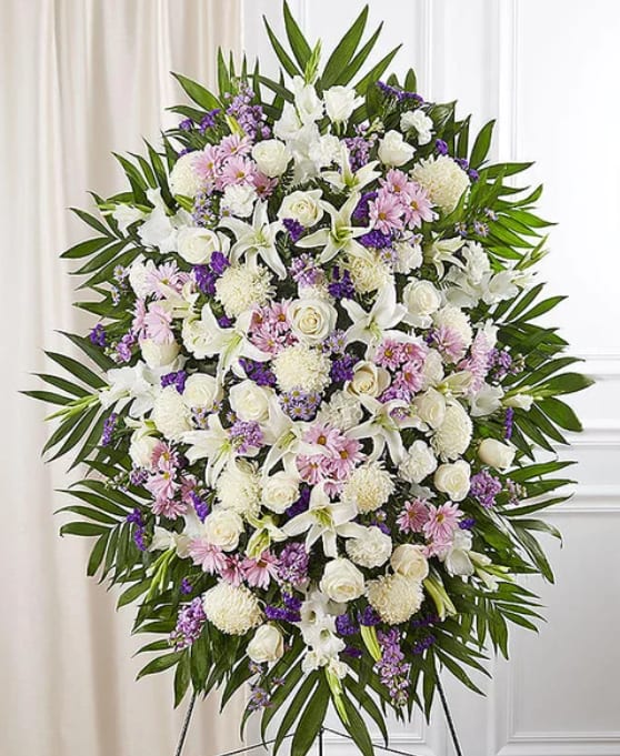 Standing floral spray of white, pink, and purple flowers on an easel