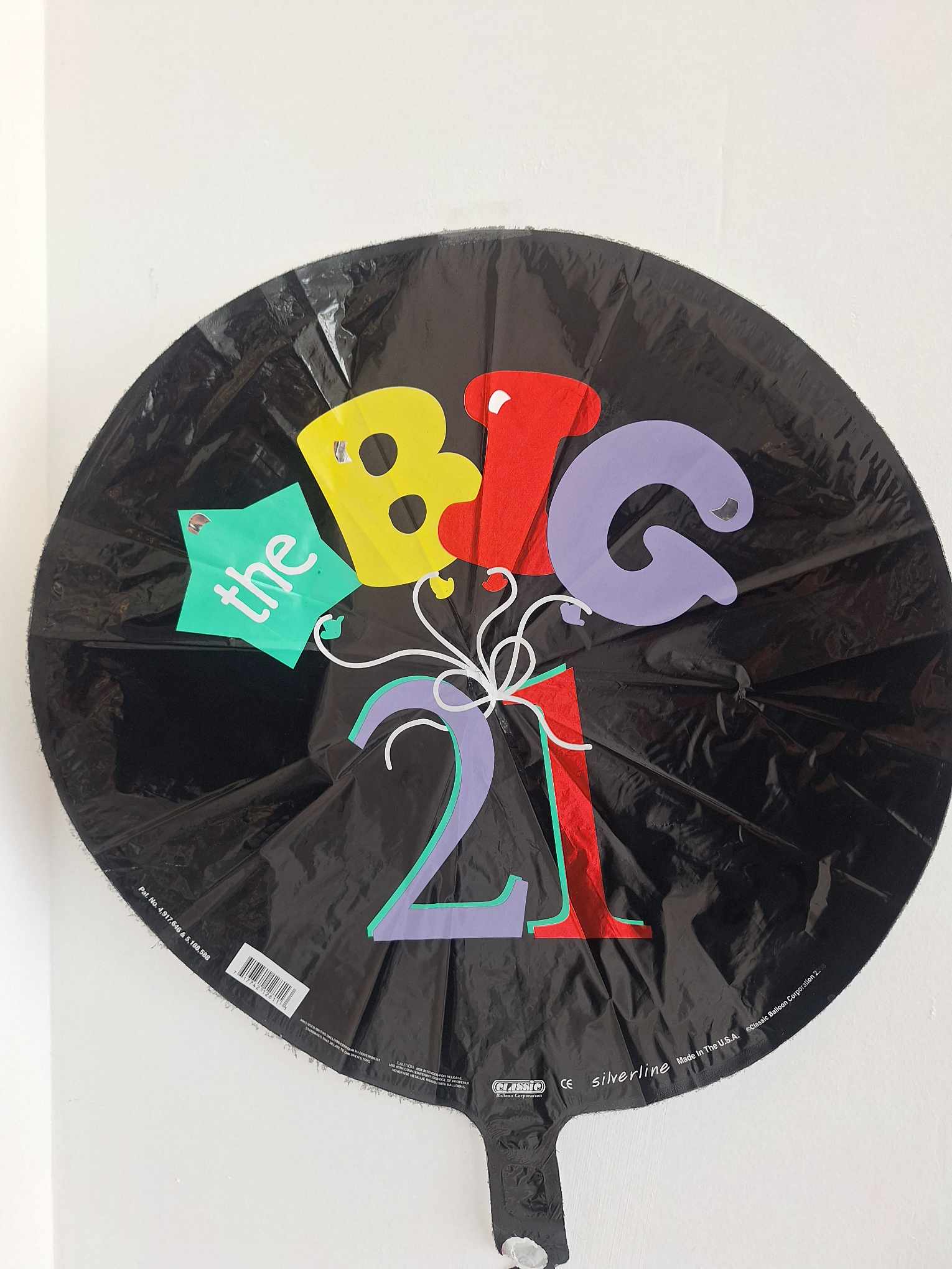 Black round balloon with colorful "the BIG 21" text