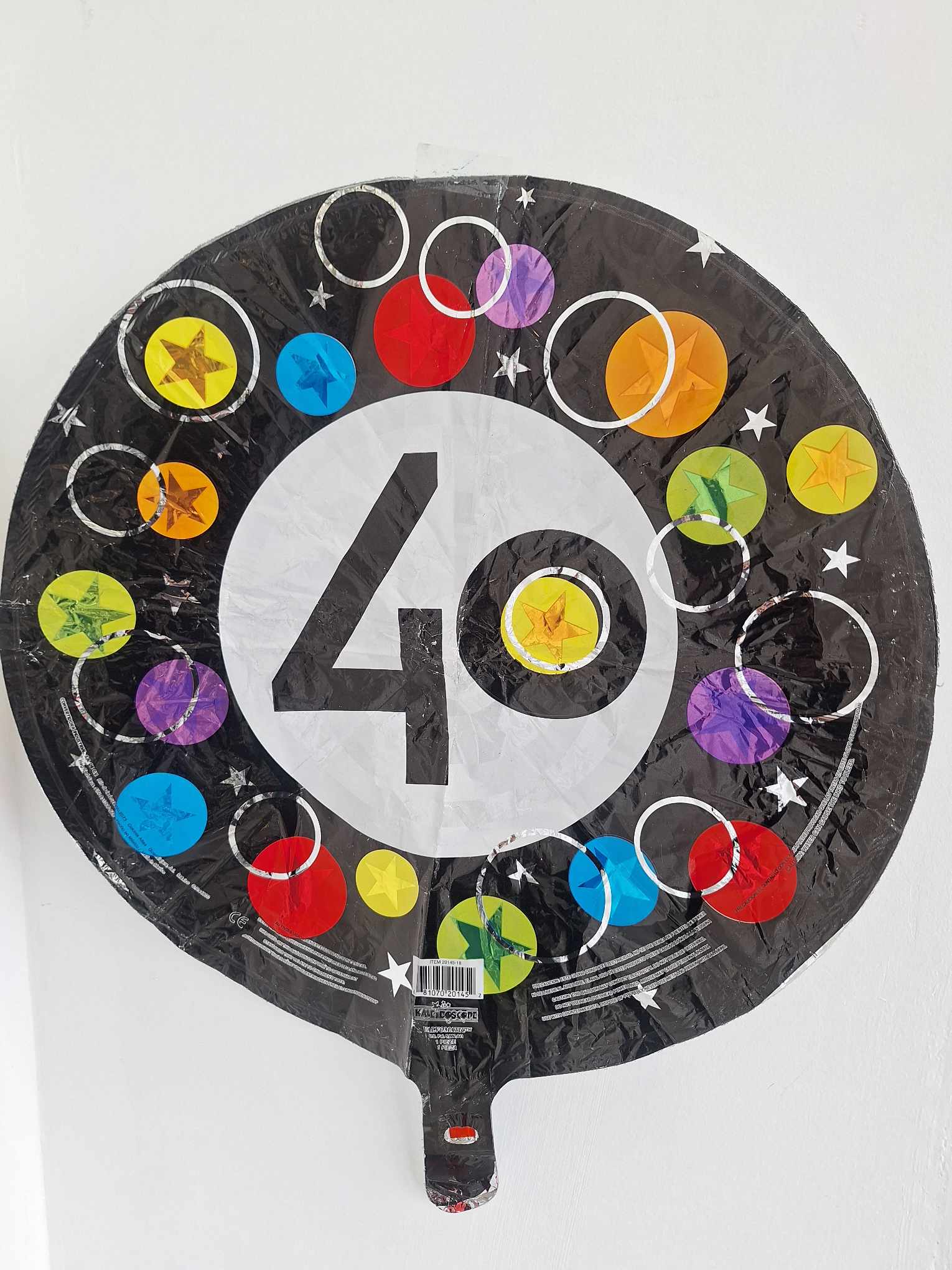 Round black balloon with a large white 40 and colorful circles