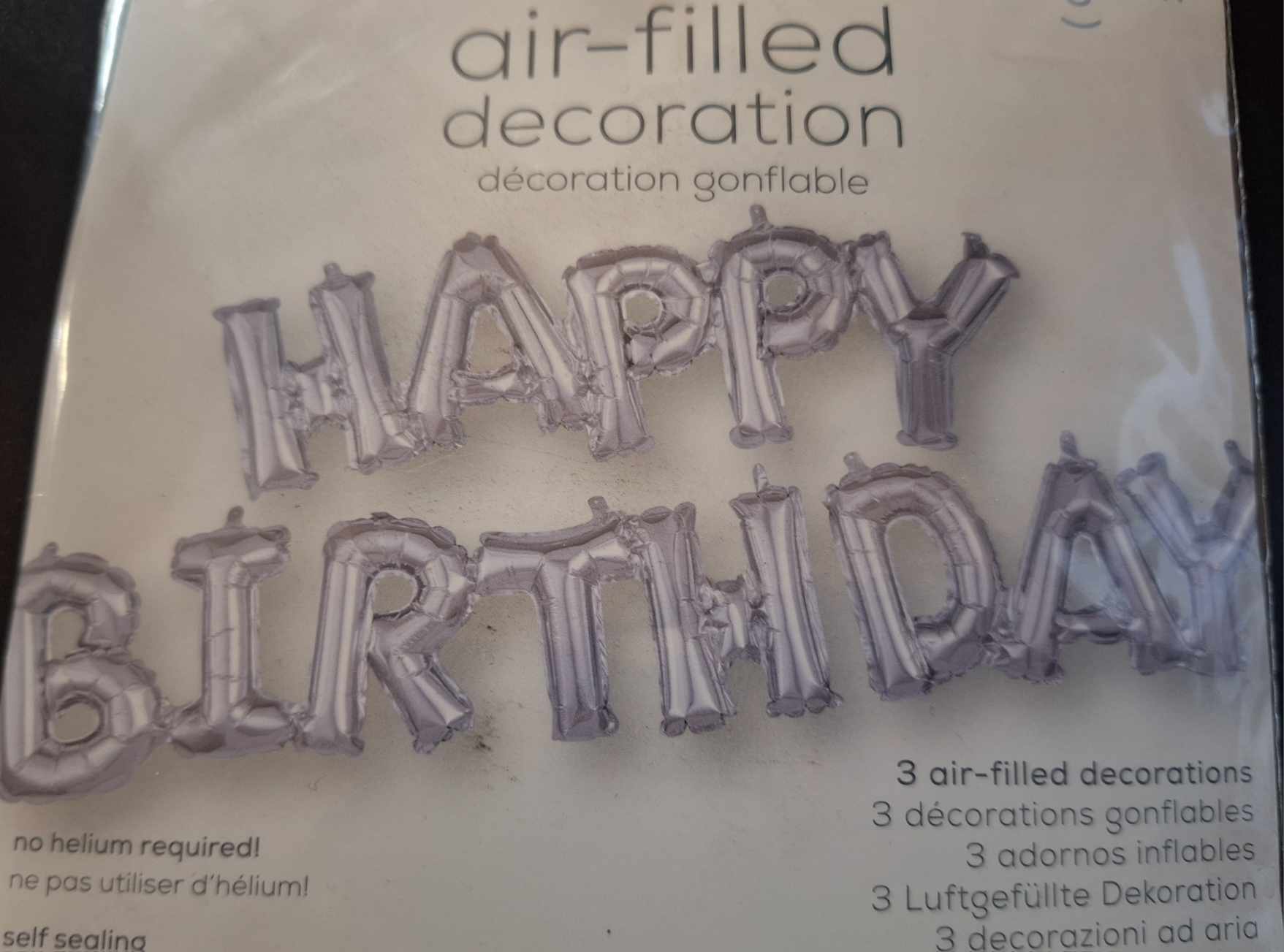 Silver birthday letter balloons spelling Happy Birthday