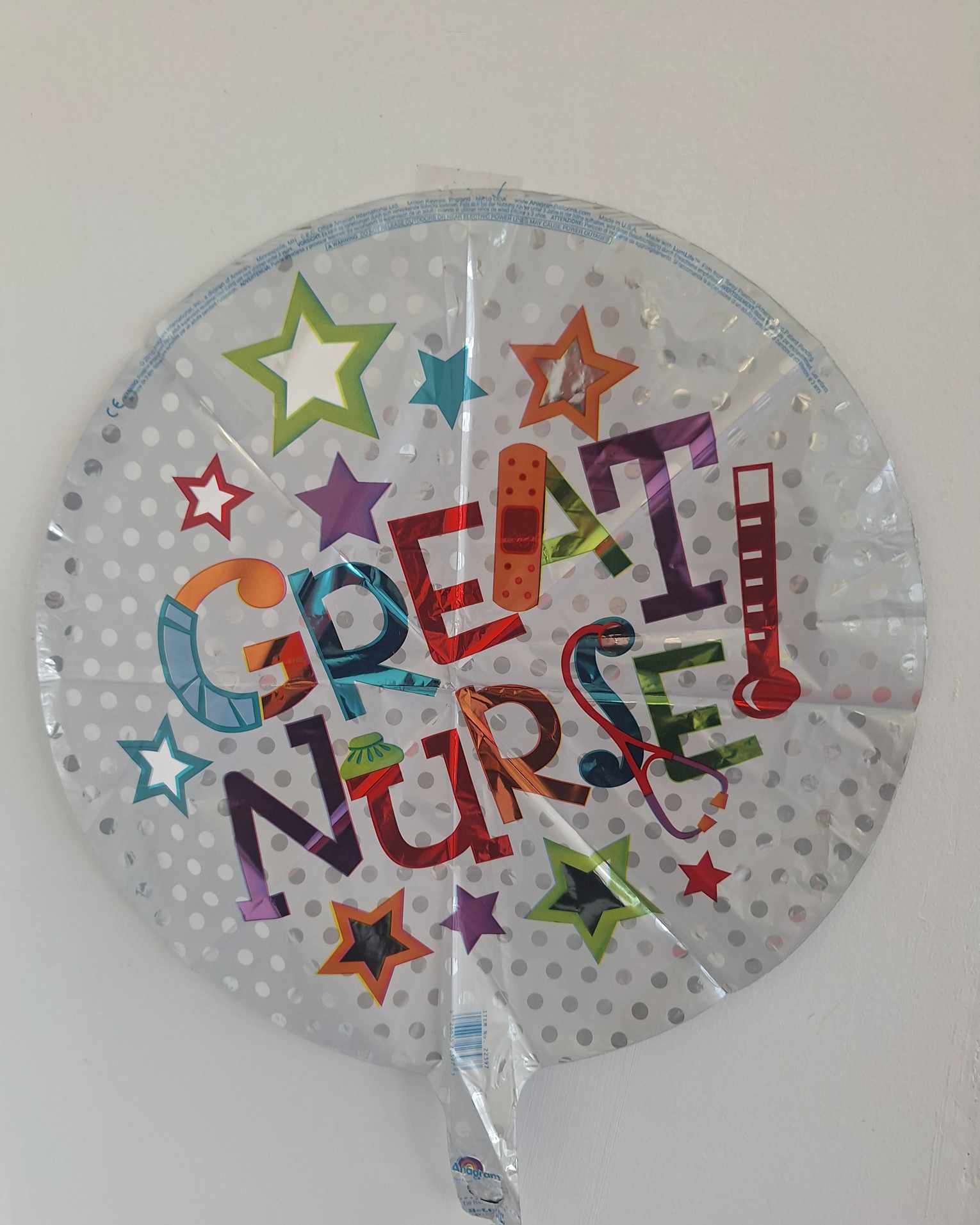 Round foil balloon with colorful "Great Nurse" text and stars