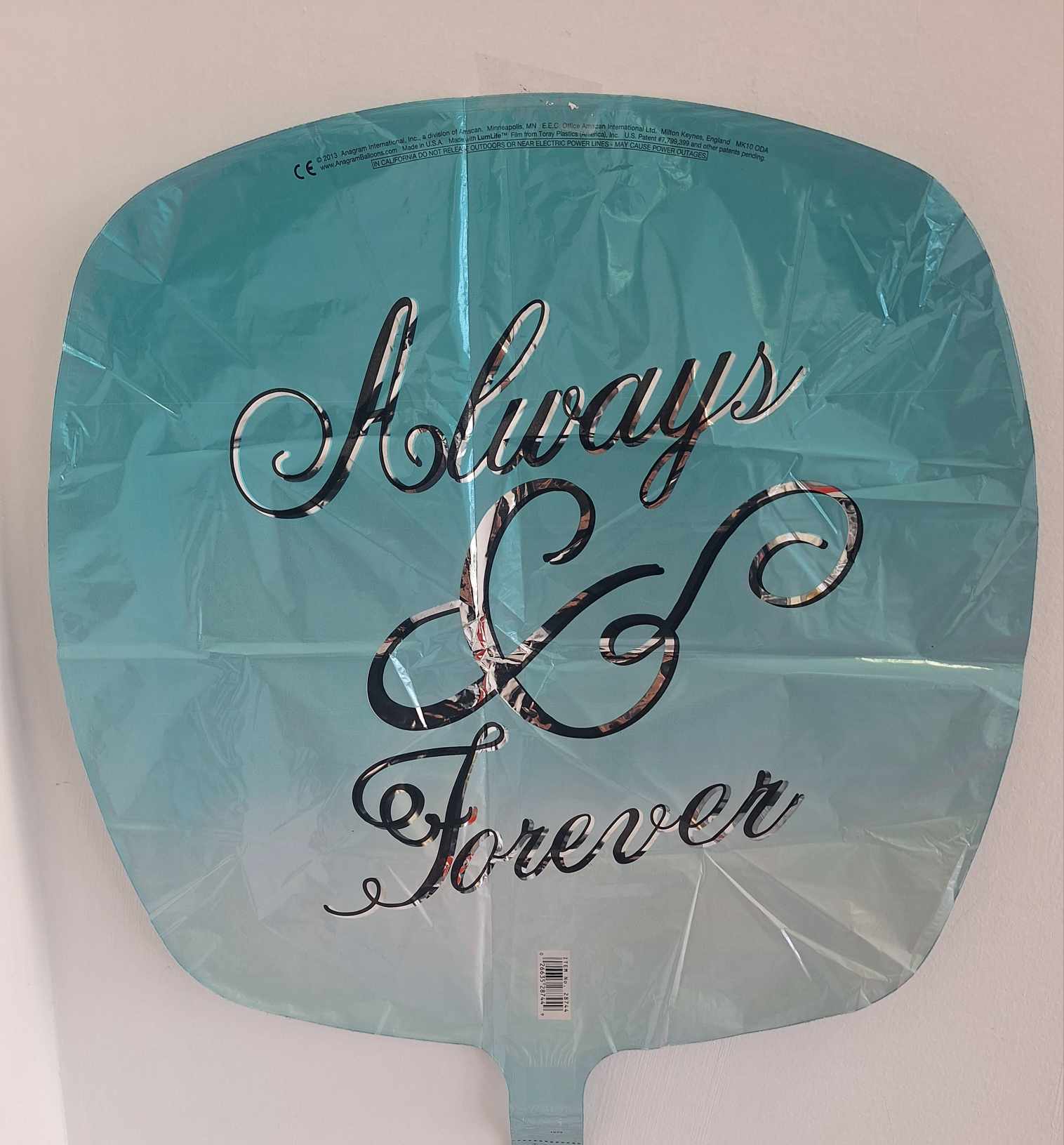 Teal foil balloon with silver script text reading “Always &amp; Forever.”
