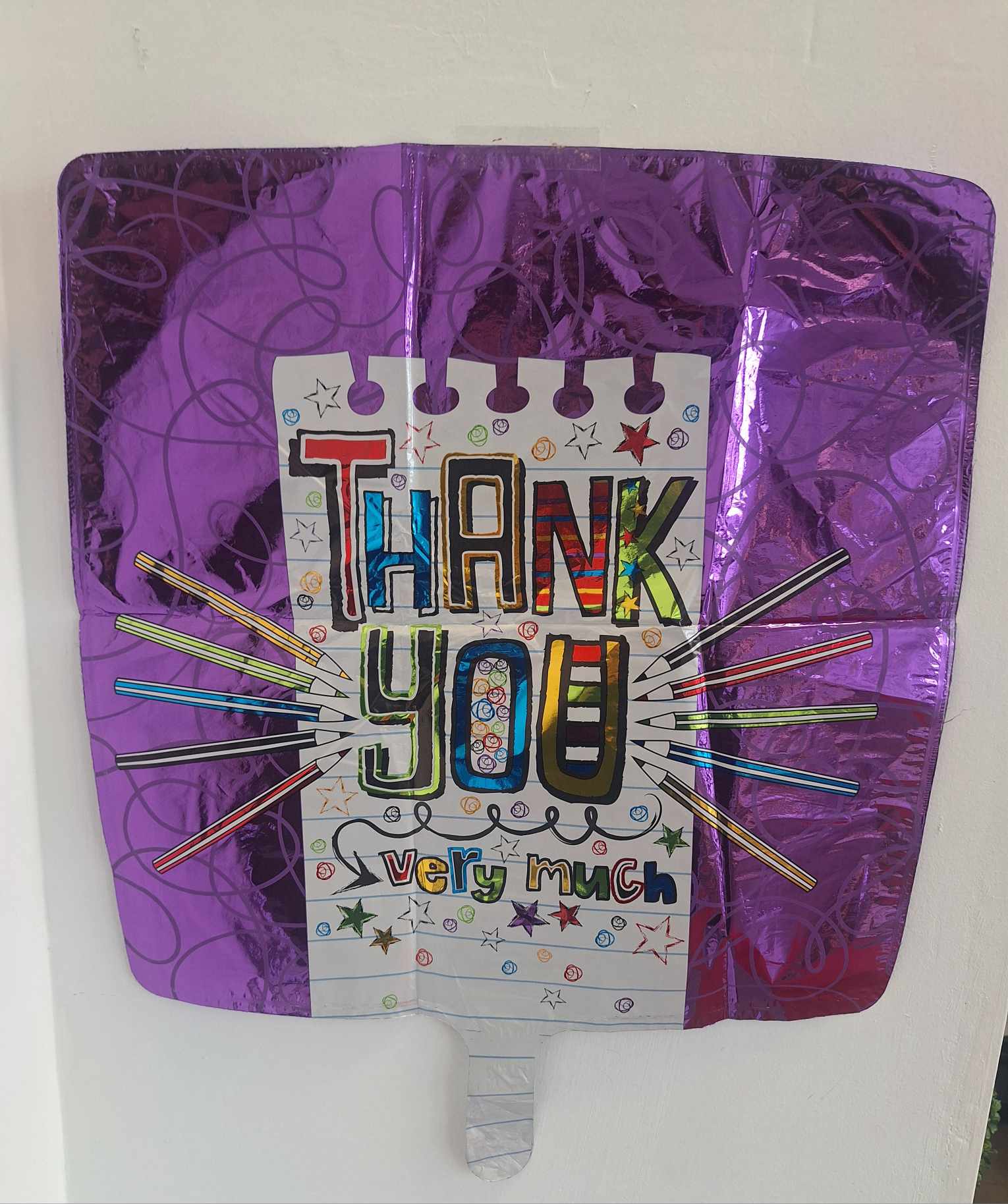 Purple thank-you balloon with colorful hand-drawn lettering