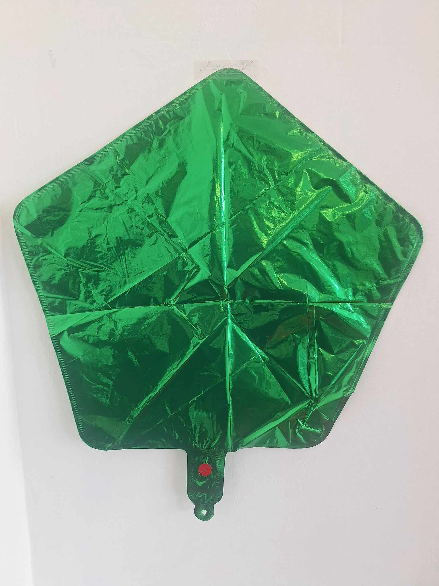 Green foil balloon shaped like a Christmas tree