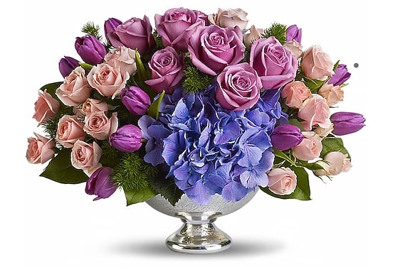 Lavender roses and blue hydrangea in a silver pedestal vase
