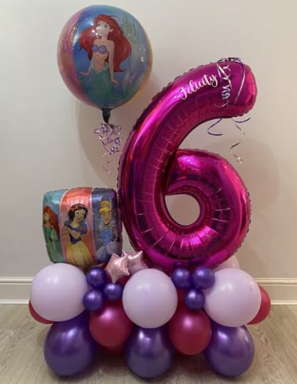 Princess-themed balloon arrangement with a large pink number 6 balloon
