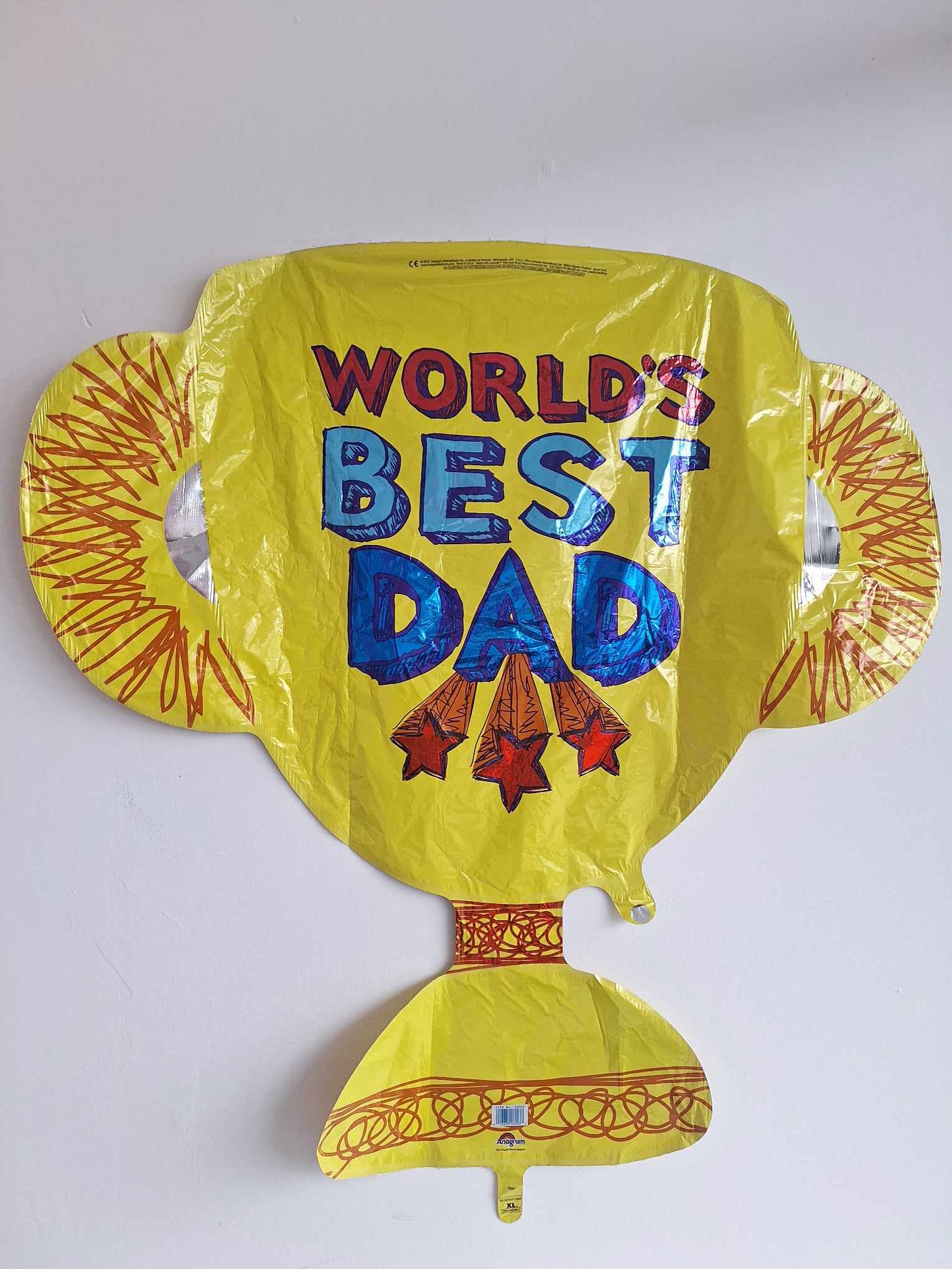 Yellow foil balloon reading "World's Best Dad"