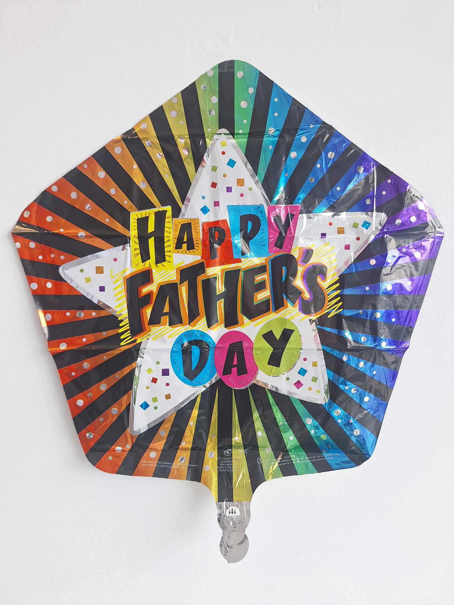 Rainbow foil balloon reading Happy Father's Day