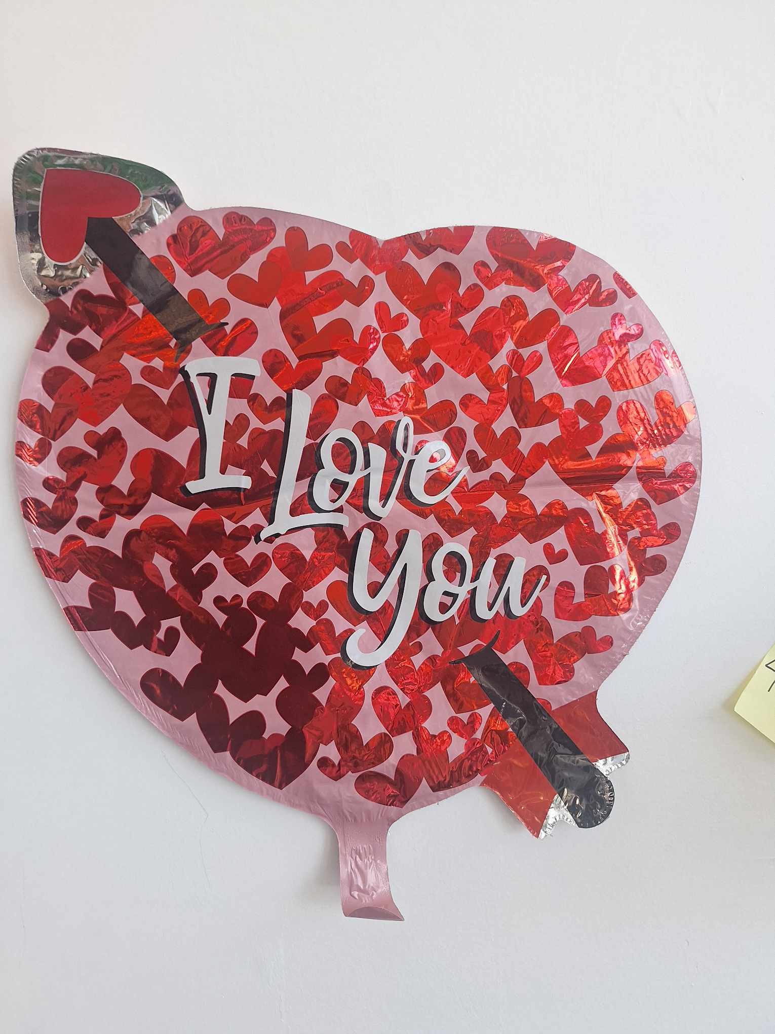Heart-shaped foil balloon with "I Love You" text and red hearts