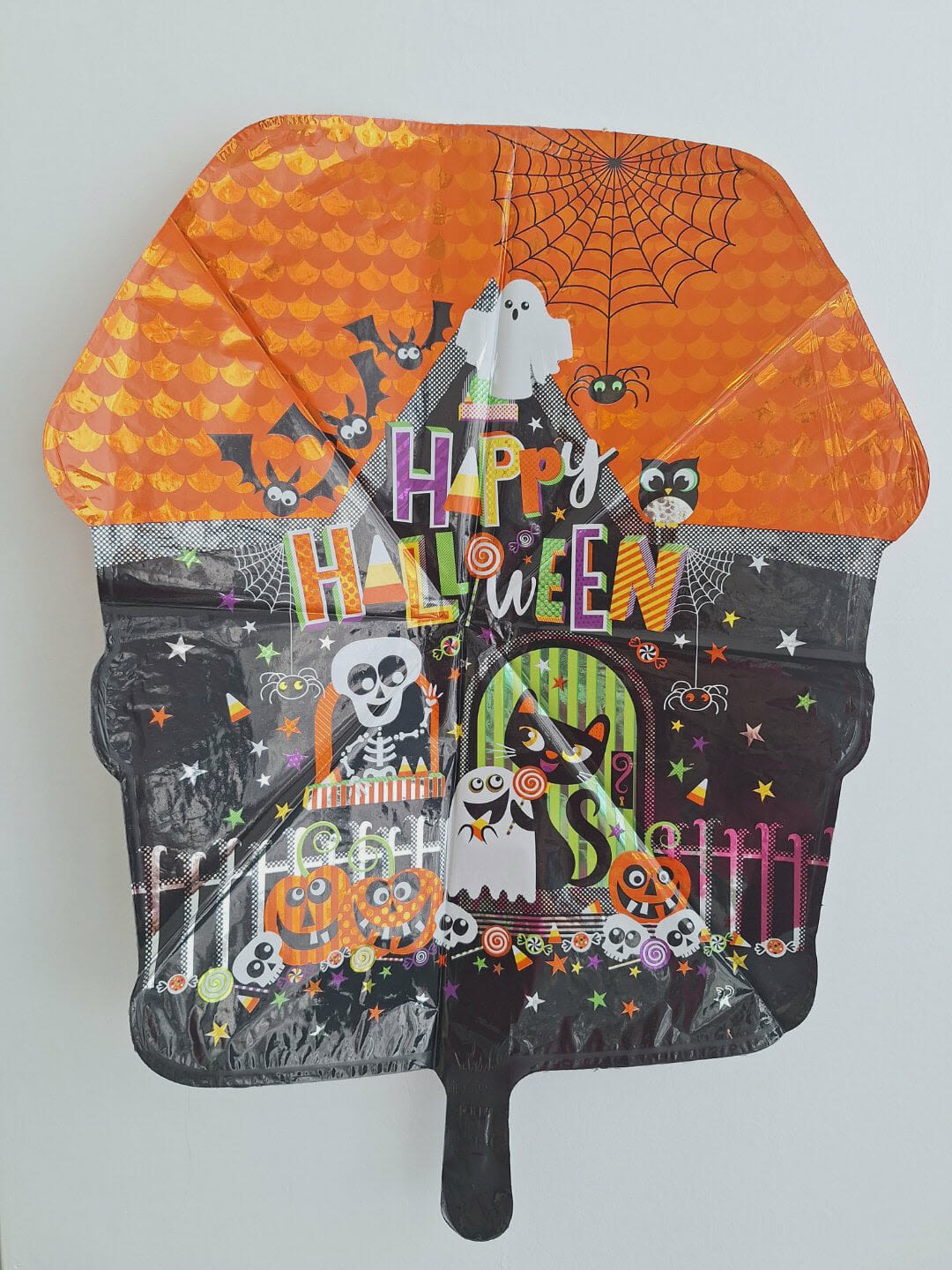 Halloween-themed foil balloon with ghosts, bats, and spiders