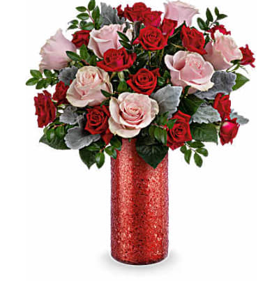Bouquet of red and pale pink roses in a red vase