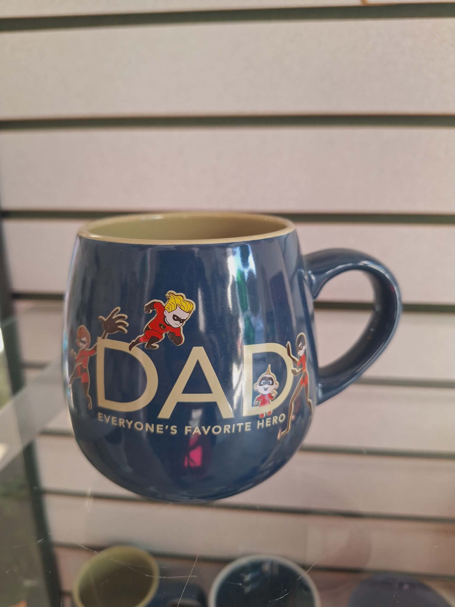 Blue mug with "DAD" text and superhero characters