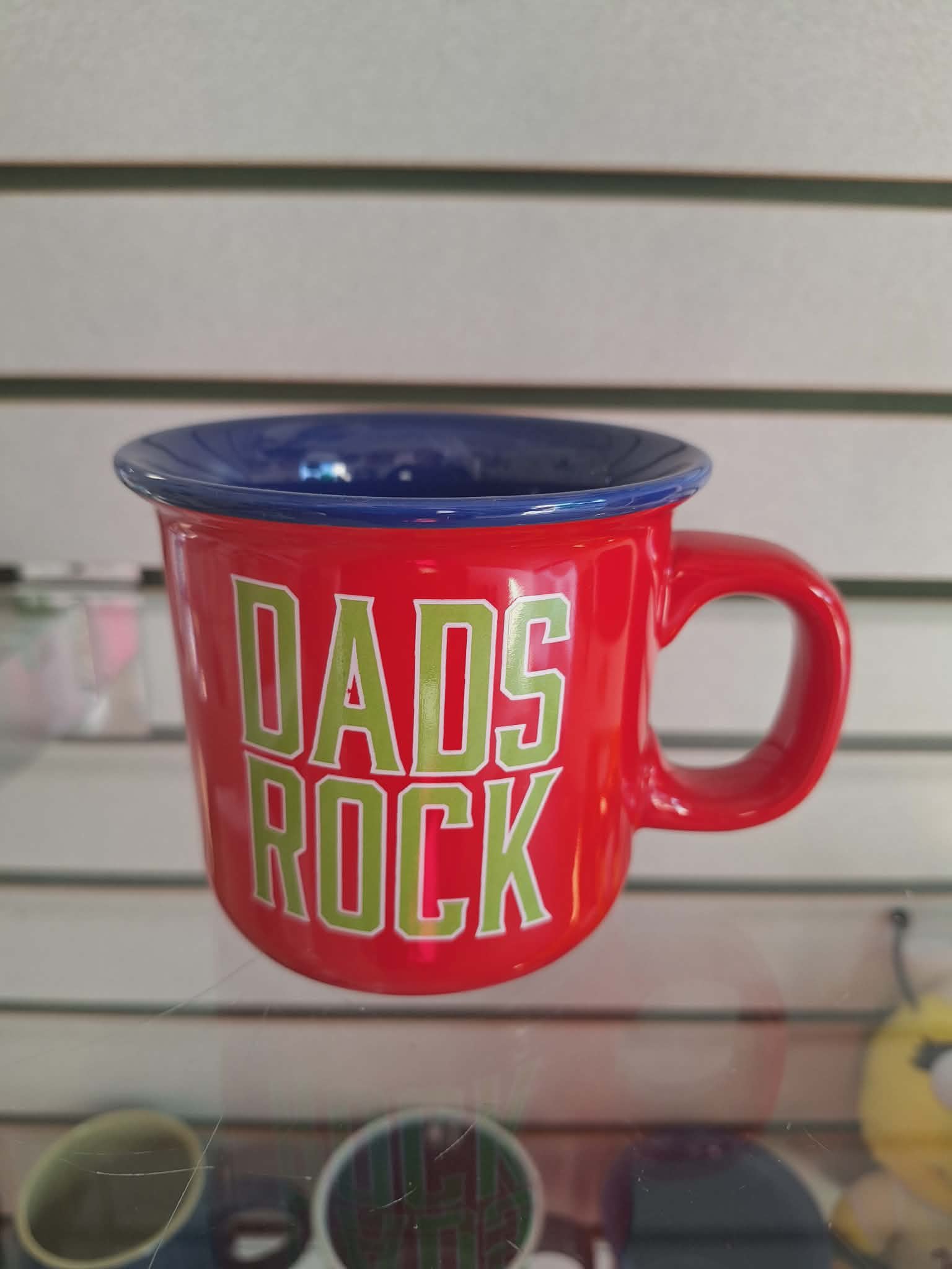 Red mug with blue rim and "DADS ROCK" text