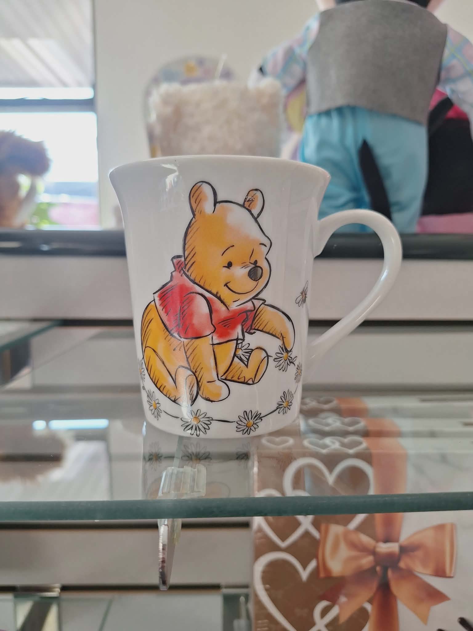 White mug with a Winnie the Pooh illustration