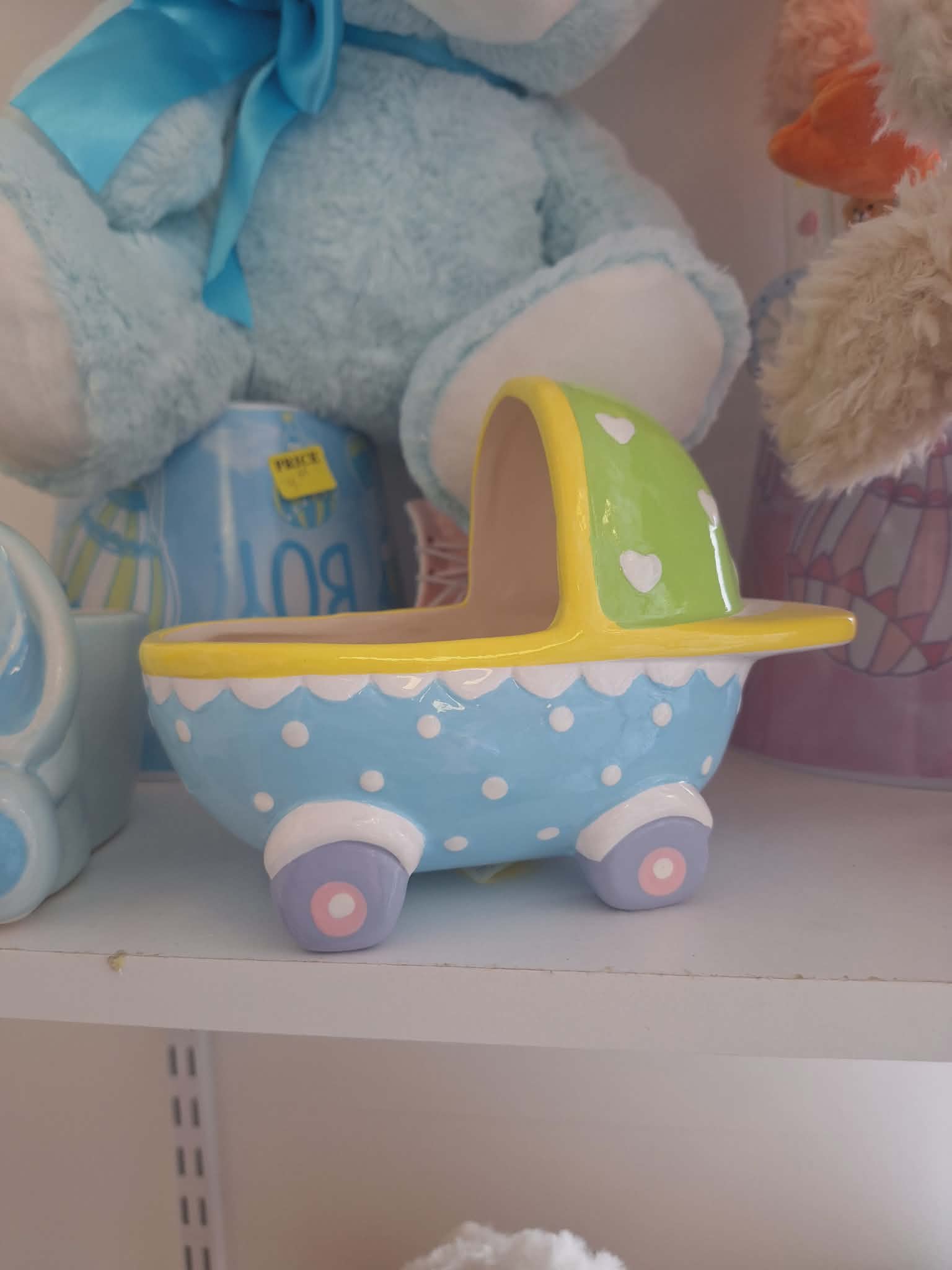 Pastel ceramic planter shaped like a baby carriage