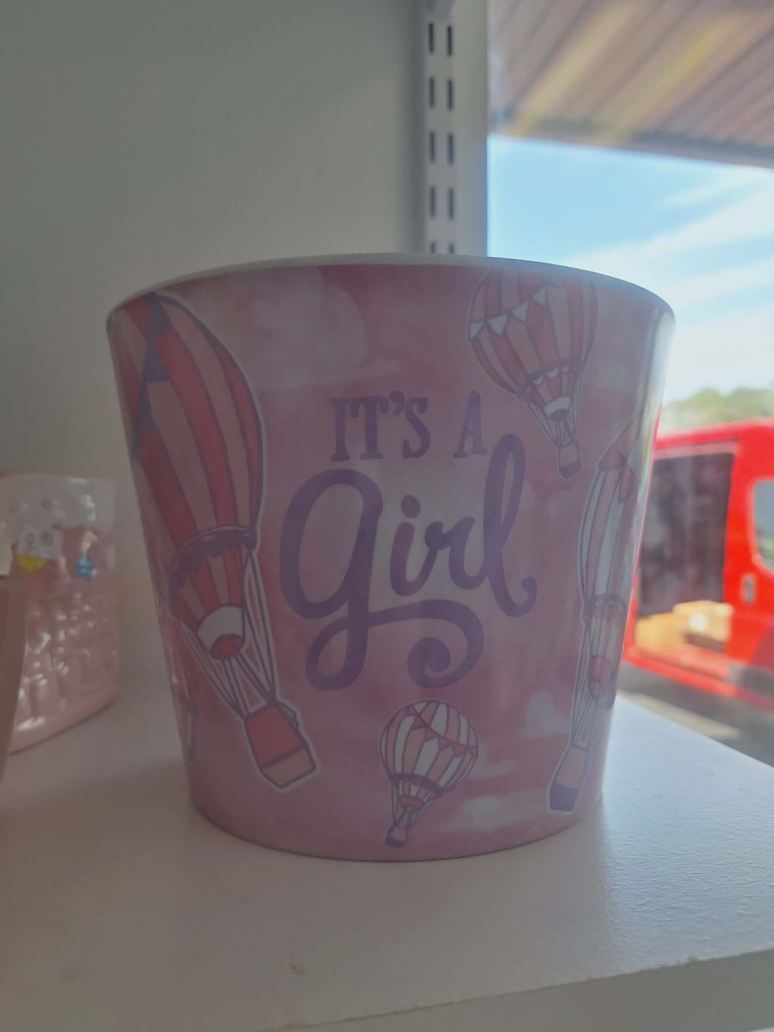 Pink pot with hot air balloons and the words "It's A Girl"