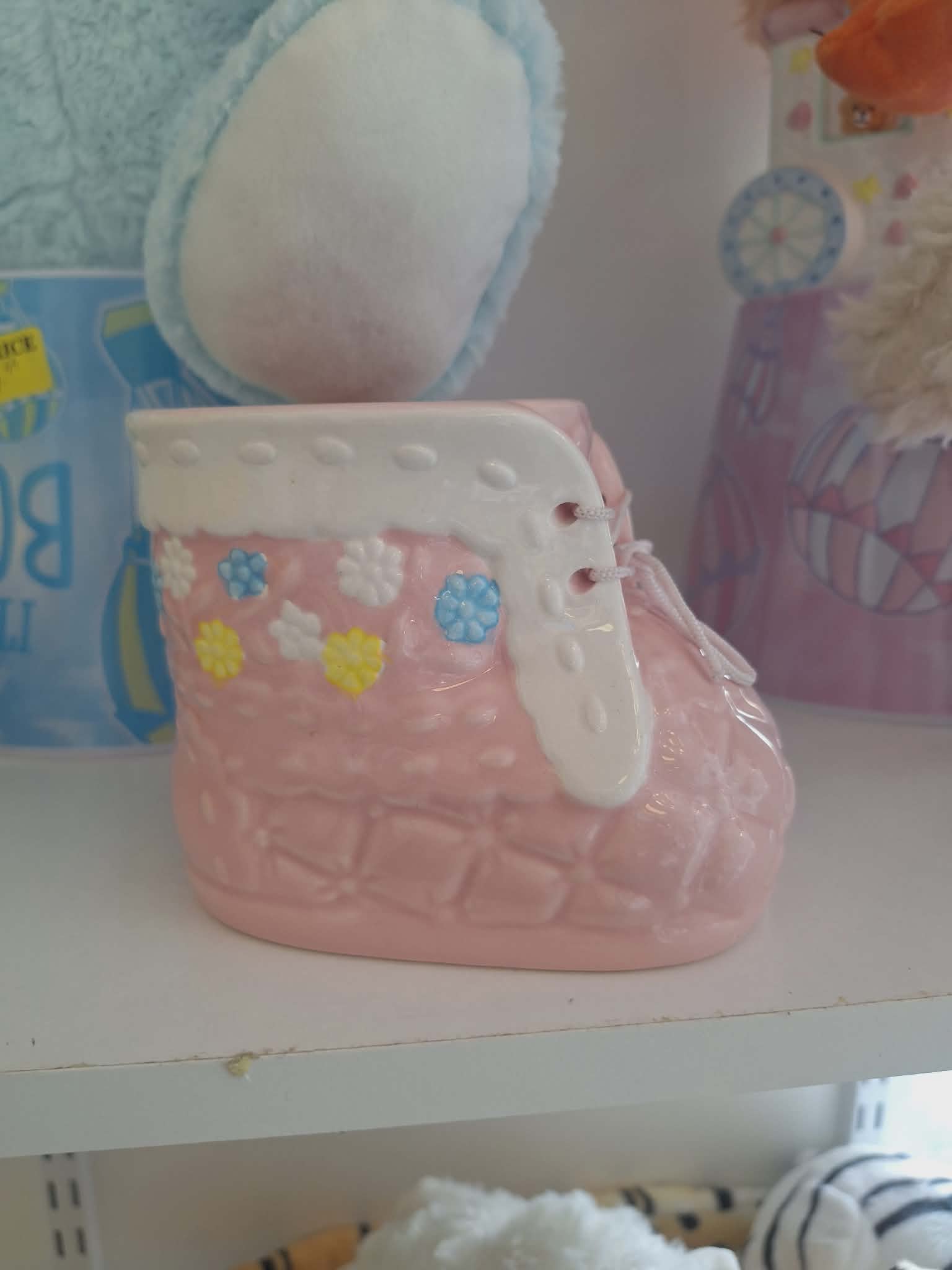 Pink ceramic baby bootie with colorful flower accents