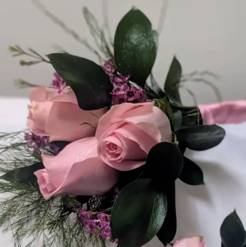 Pink Rose Boutonniere - Pink roses w/ greenery can come in either fresh or silk flowers. The deluxe version includes a matching corsage. The roses can come in a variety of colors include color choice in the notes if ordering online.
