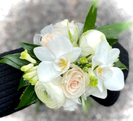 Roses/ Orchids Prom Corsage - Roses with orchids a hint of greenery. The deluxe version includes a matching boutonniere. The roses can come in a variety of colors, include color choice in the notes if ordering online. It also can come in fresh or silk flowers.