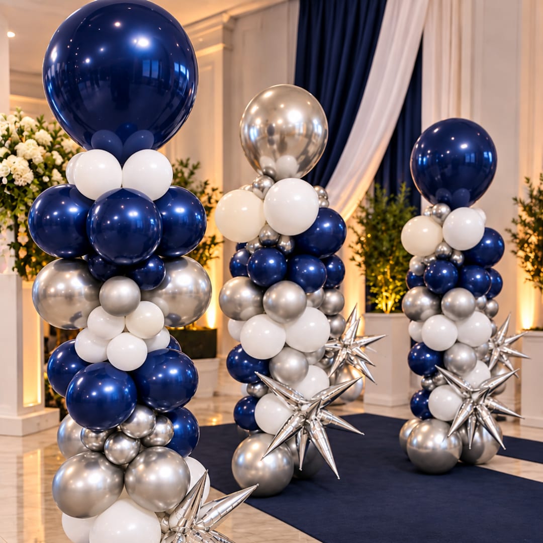 Tall balloon columns in navy, silver, and white with star accents