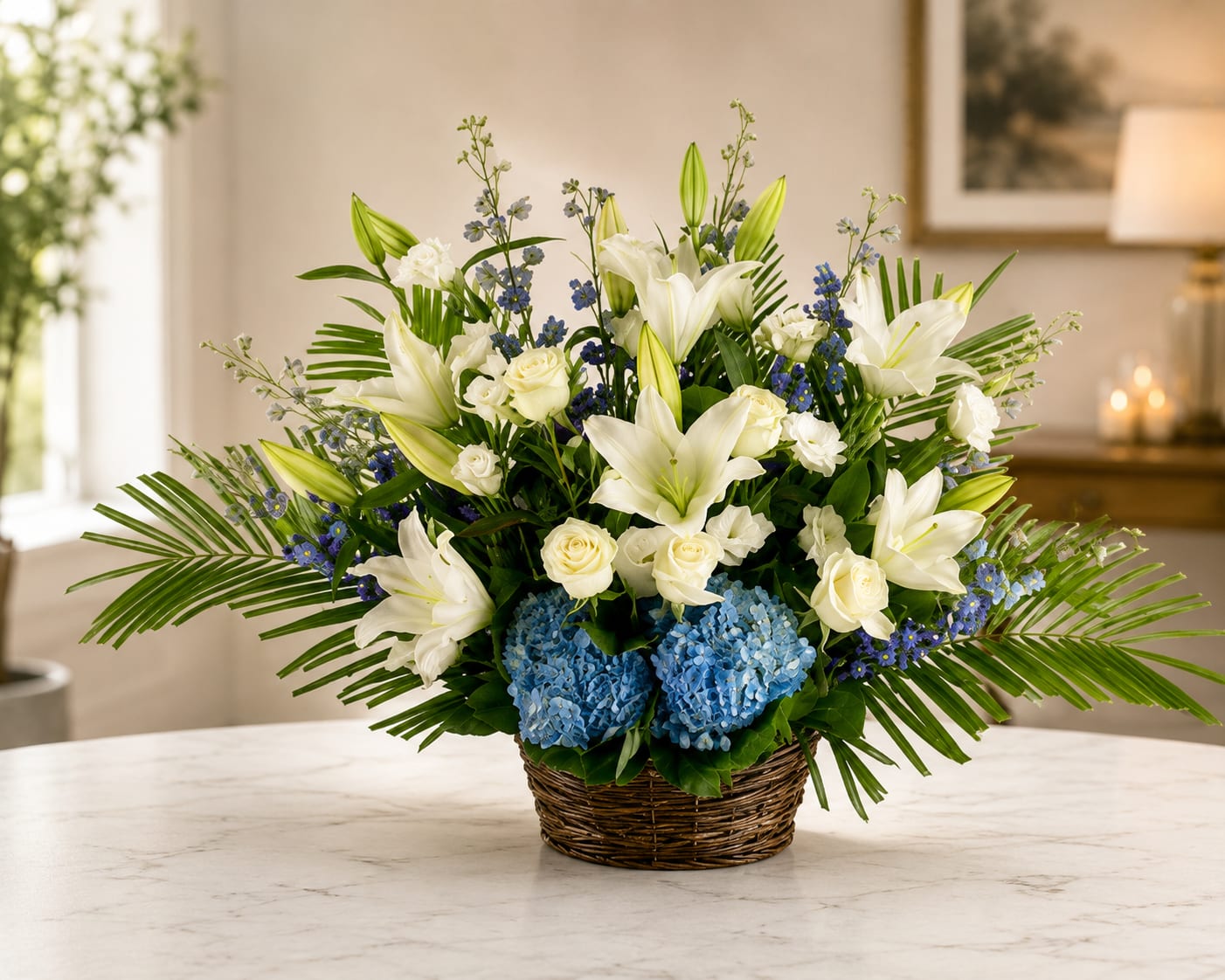 Blue Horizon Elegance - A blue, white, and green funeral basket for any type of service. Held in a wicker basket, large palms spread out and give a natural spotlight for the feature blooms and colors.