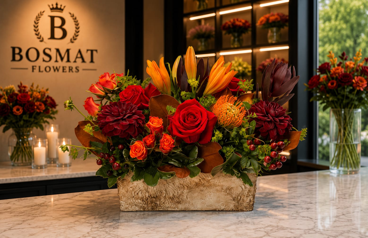 Mixed floral arrangement with red roses, orange lilies, and dark burgundy blooms in a rectangular vase