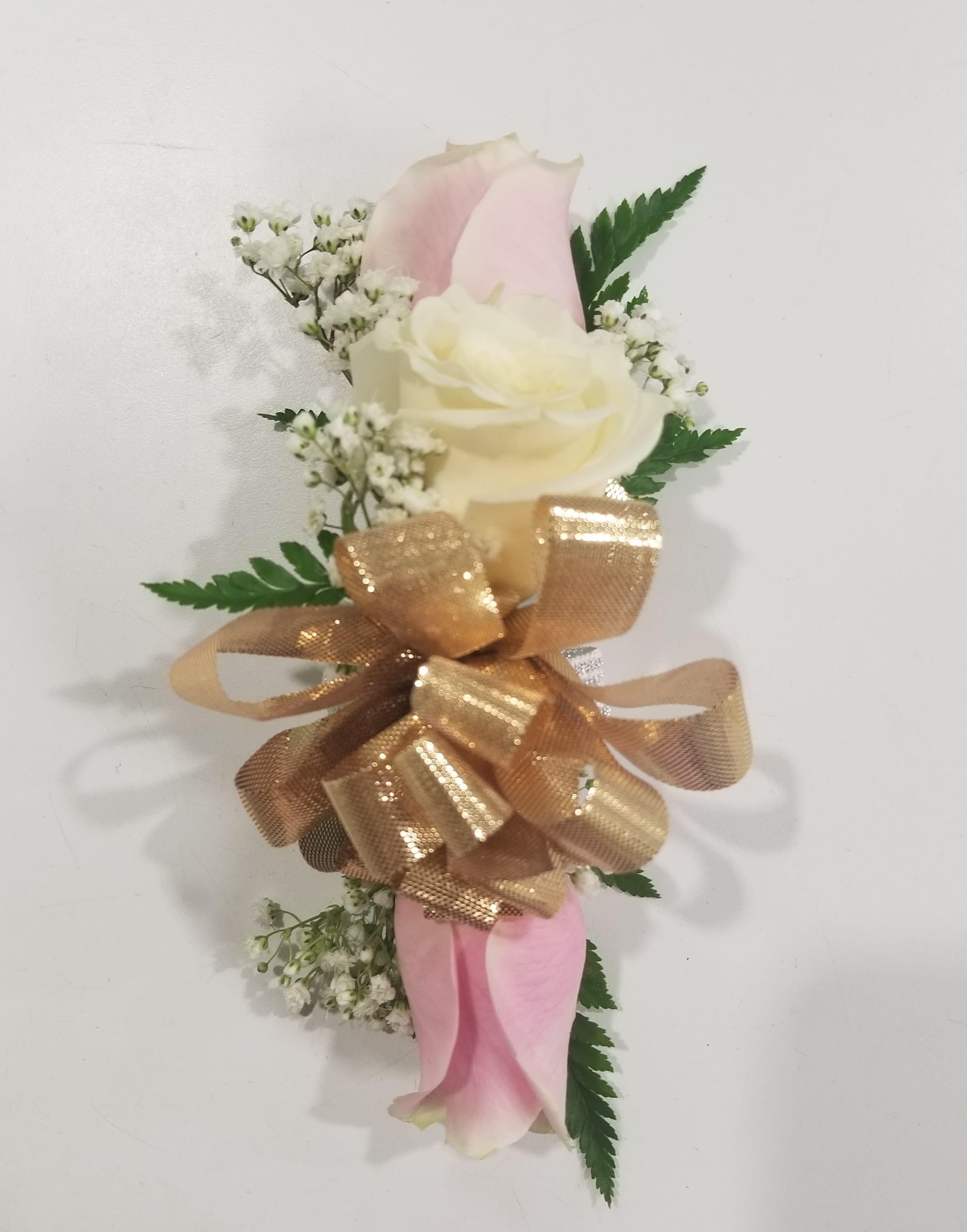 Pink and white calla lily corsage with gold ribbon