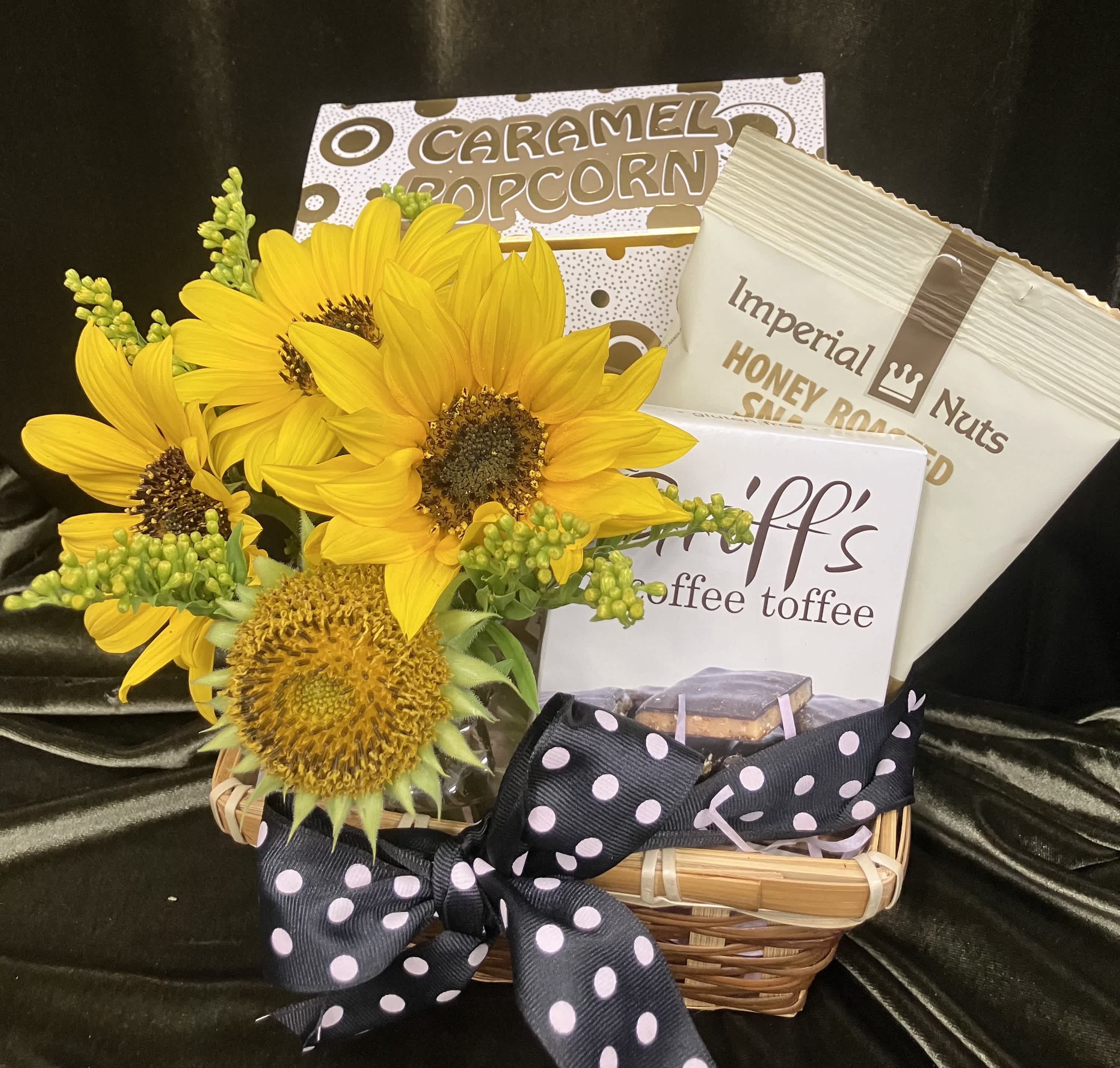 Sunflowers in a basket with caramel popcorn, nuts, and coffee toffee.