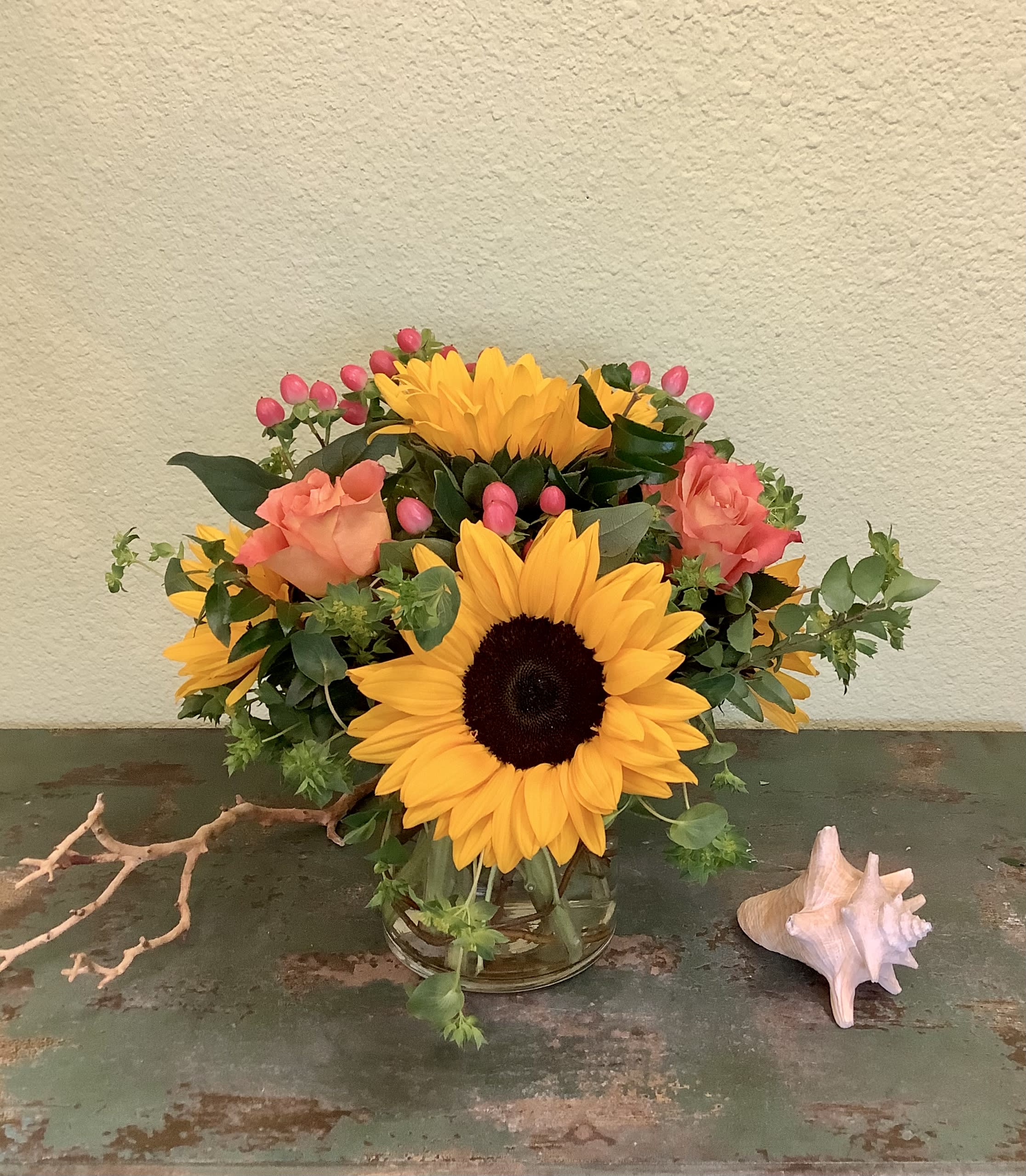 Sunny Sunflowers - Mixed arrangement of cheerful sunflowers, gorgeous roses and complimentary blooms designed in a curly willow vase. The perfect way to brighten someone's day!  Flower colors may vary from week to week.  Please call if this is a concern.
